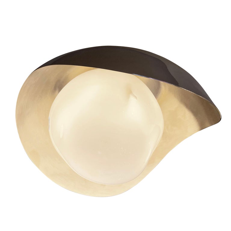 The Perla flush mount features an organic brass shell nestling our sfera glass handblown in Tuscany. Shown in a two-tone finish with a polished nickel exterior and satin nickel interior. Can also be installed as a wall light.

Customization
