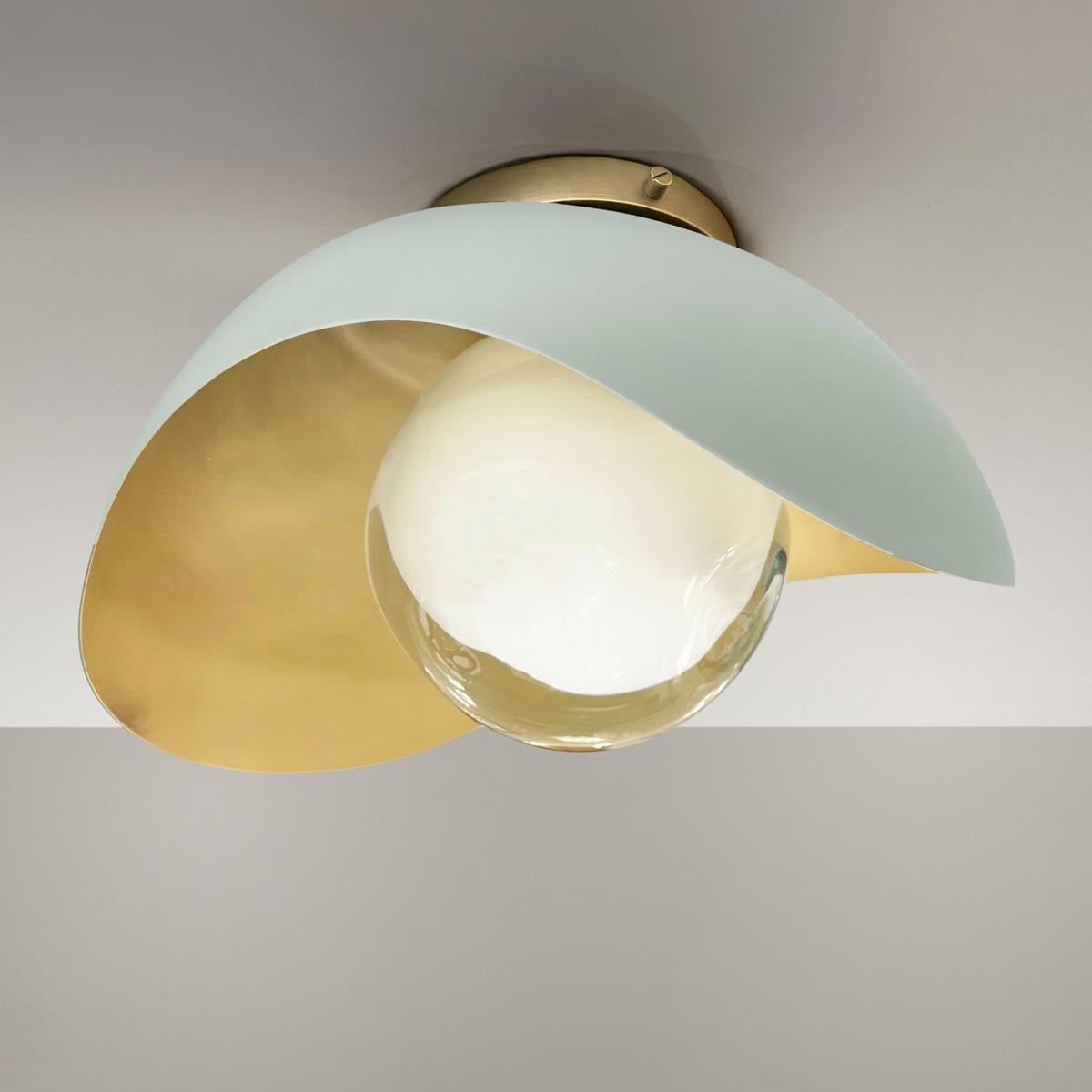 The Perla flushmount features an organic brass shell nestling our Sfera glass handblown in Tuscany. The first images show the fixture with a satin brass interior and Lerici Acqua exterior finish-subsequent pictures show it in a selection of