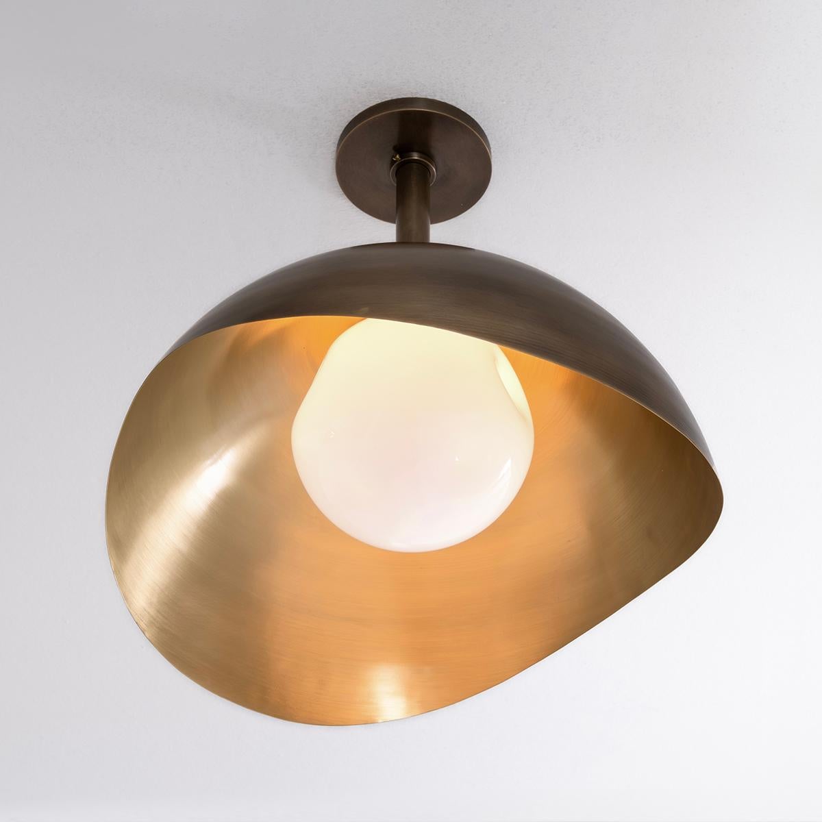 The Perla Grande features an organic brass shell nestling our sfera glass handblown in Murano. Shown in a two tone finish with a bronzo nuvolato exterior and satin brass interior. See our Perla flushmount and wall light for the smaller version.