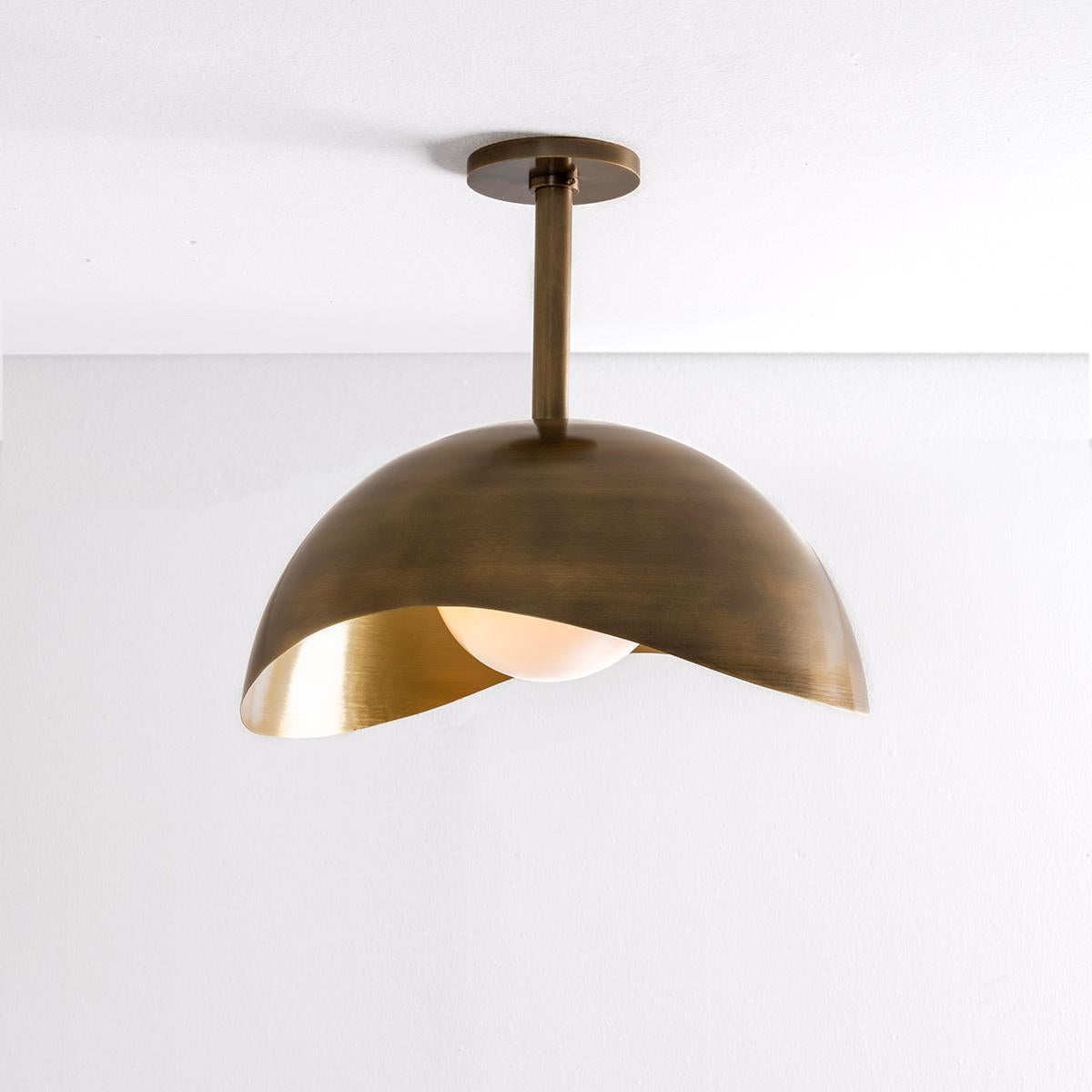 The Perla Grande features an organic brass shell nestling our sfera glass handblown in Murano. Shown in a two tone finish with a bronzo nuvolato exterior and satin brass interior. See our Perla flushmount and wall light for the smaller version.