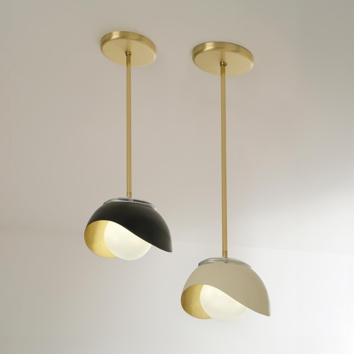 The Perla Pendant features an organic brass shell nestling our Sfera glass handblown in Tuscany. Also available as a flush mount or wall light. See the Perla Mini for the smaller version and the Perla Grande for the larger version.

Shown in the