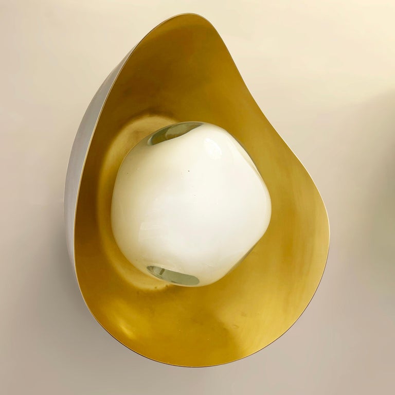The Perla wall light features an organic brass shell nestling our sfera glass handblown in Tuscany. Shown in a two tone finish with a brunito nero exterior and satin brass interior. Can also be installed as a flushmount ceiling light.

Customization