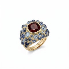 Perle de Pluie Garnet Ring in 18k Gold with Blue Topazes by MARIANNE CANARELLI