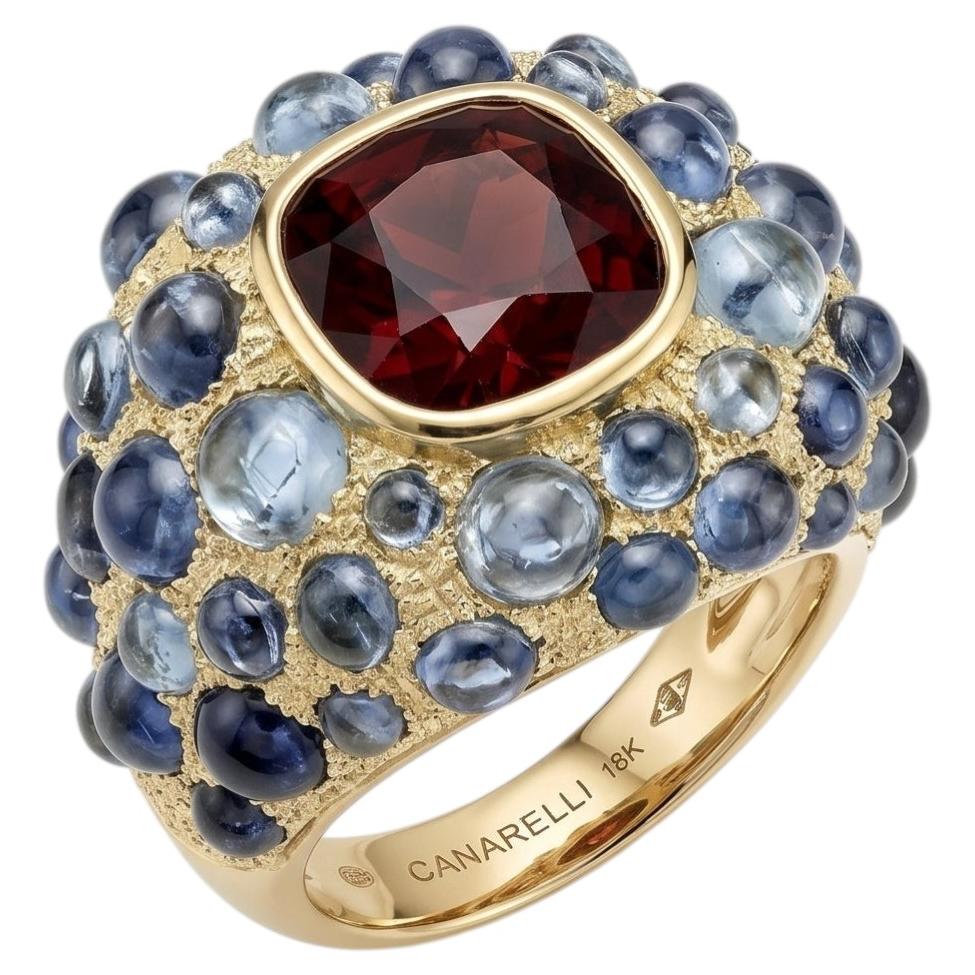 Perle de Pluie Garnet Ring in 18k Gold with Blue Topazes by MARIANNE CANARELLI