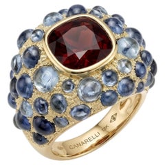 Perle de Pluie Garnet Ring in 18k Gold with Blue Topazes by MARIANNE CANARELLI