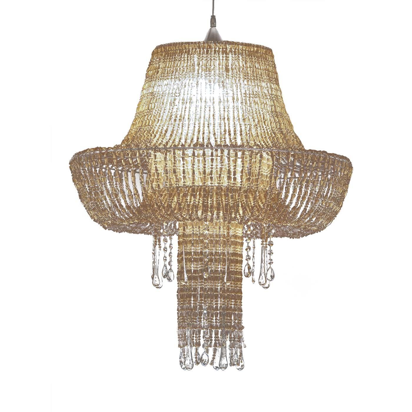 Supported by a chrome-finished metal structure, this exquisite pendant lamp showcases a grand silhouette entirely handcrafted of acrylic golden bead strands with the prized addition of pending crystal elements. The E27 bulb hosted in the diffuser