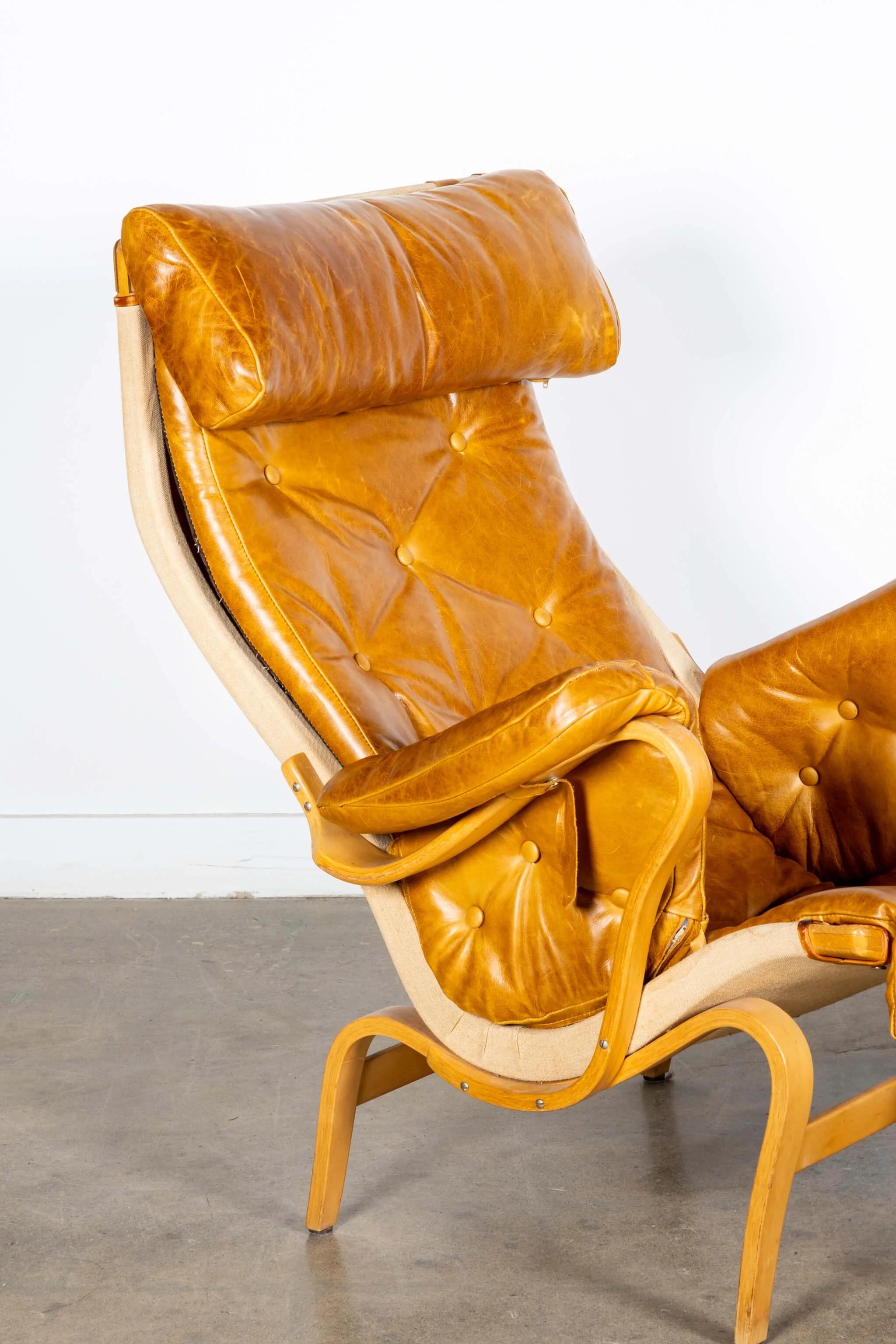 Mid-20th Century 'Pernilla 69' Leather and Beech Chair and Ottoman by Bruno Mathsson for Dux For Sale