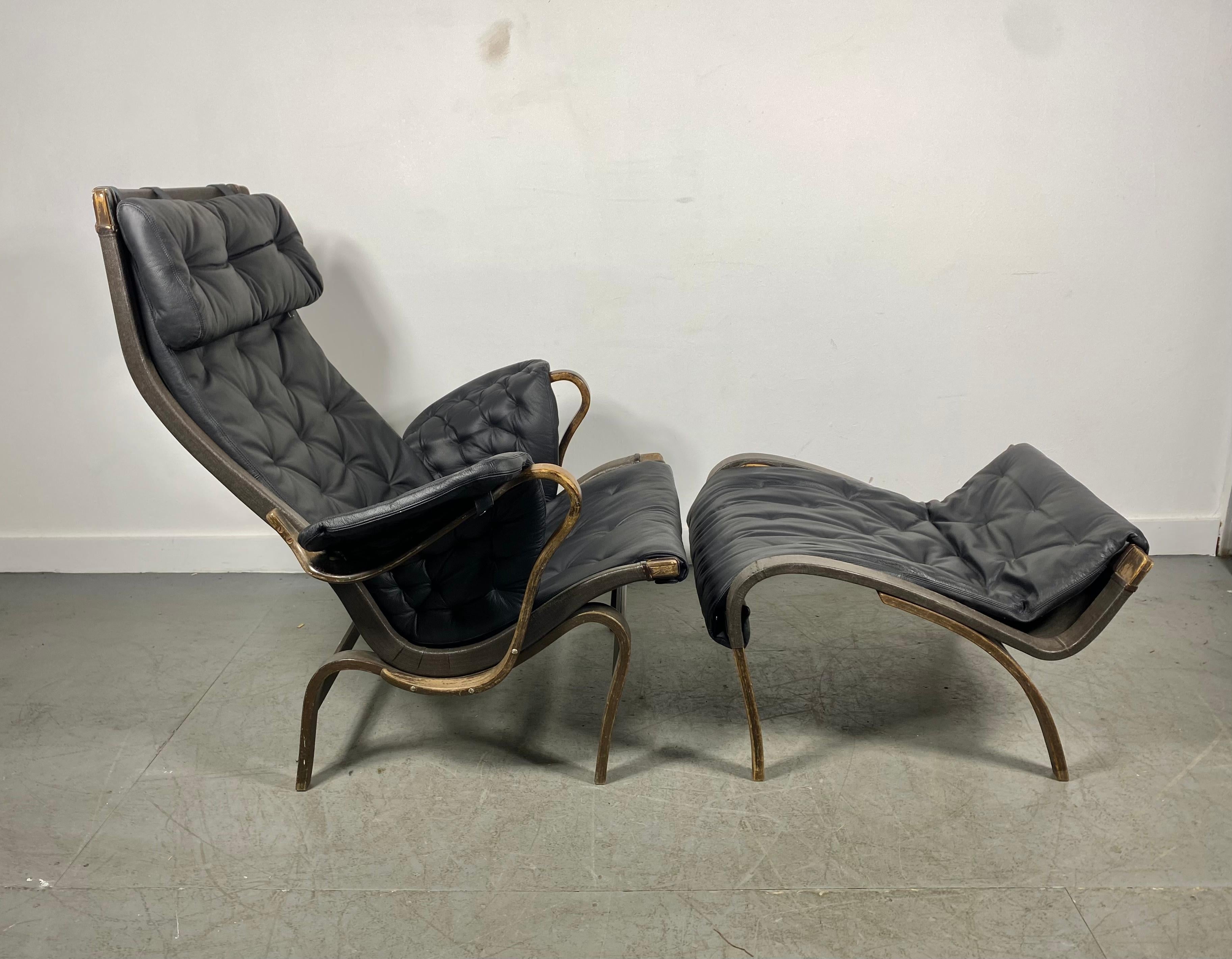 A Pernilla leather lounge chair and ottoman Designed by Bruno Mathsson and made by Dux. 1960s.

Leather and canvas on a bentwood beech frame, organic in form.Recently professionally reupholstered in high quality leather..Distressed frame..