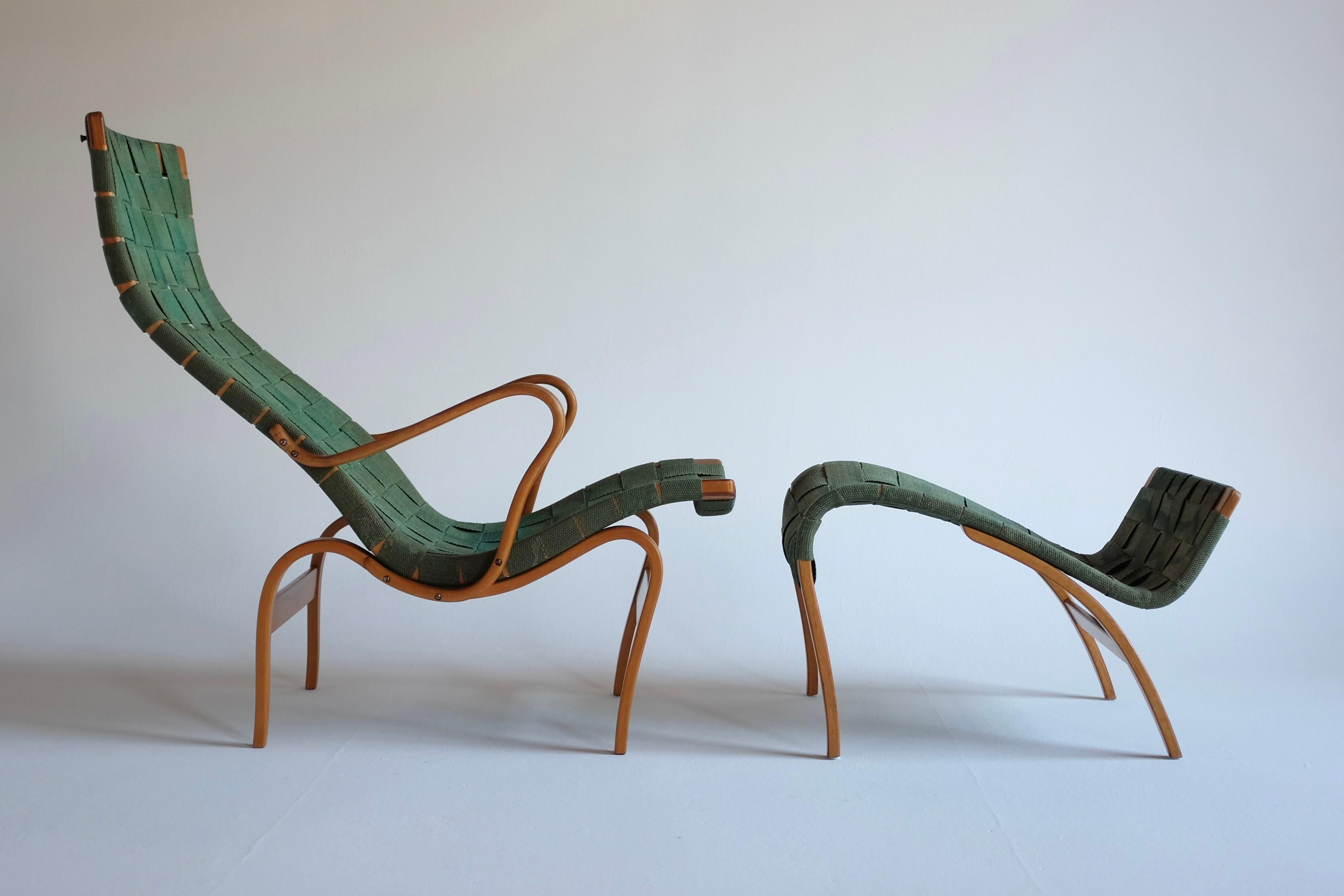 The Iconic Pernilla lounge chair and Ottoman by Bruno Mathsson for Firma Karl Mathsson. From the late 1940’s/early 1950s with the signature of the maker and designer on the chair and the Ottoman. Upholstered in a rare green webbing with age
