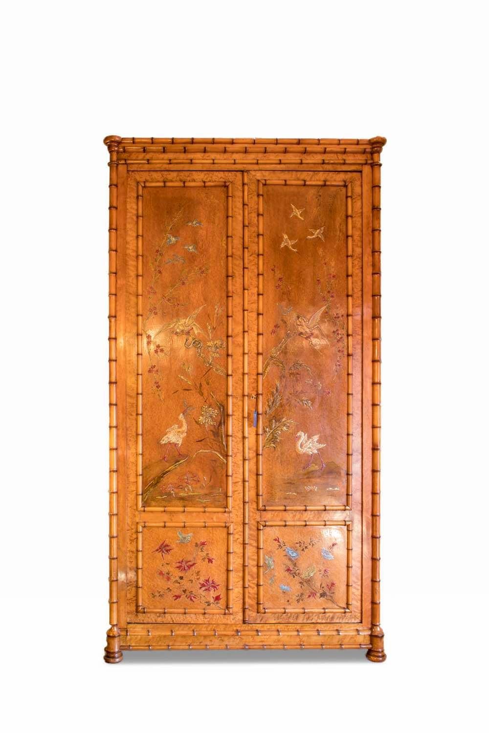 Perret et Vibert, in the style of.

Large Japonism style armoire in cherrywood and bird's-eye maple veneered, opening by two-door leaves in front. Bamboo style rails in turned wood for the whole frame structure. The armoire stands on small