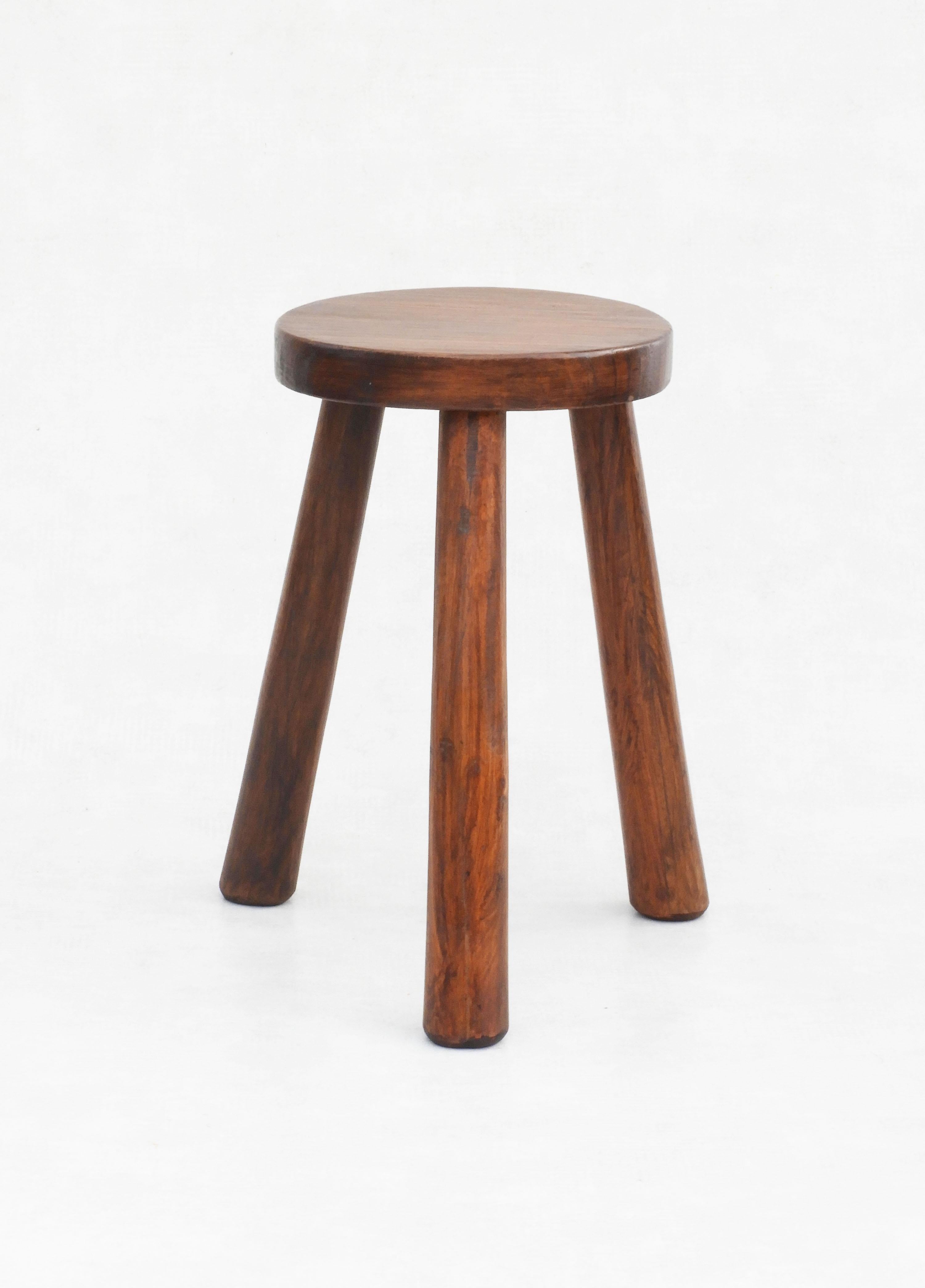 Fabulous wooden tripod stool from Mid-Century France in the style of Charlotte Perriand. 
Beautiful wood grain and texture, nice colour with good patina. 
In great vintage condition, all wood construction with no hardware and waxed