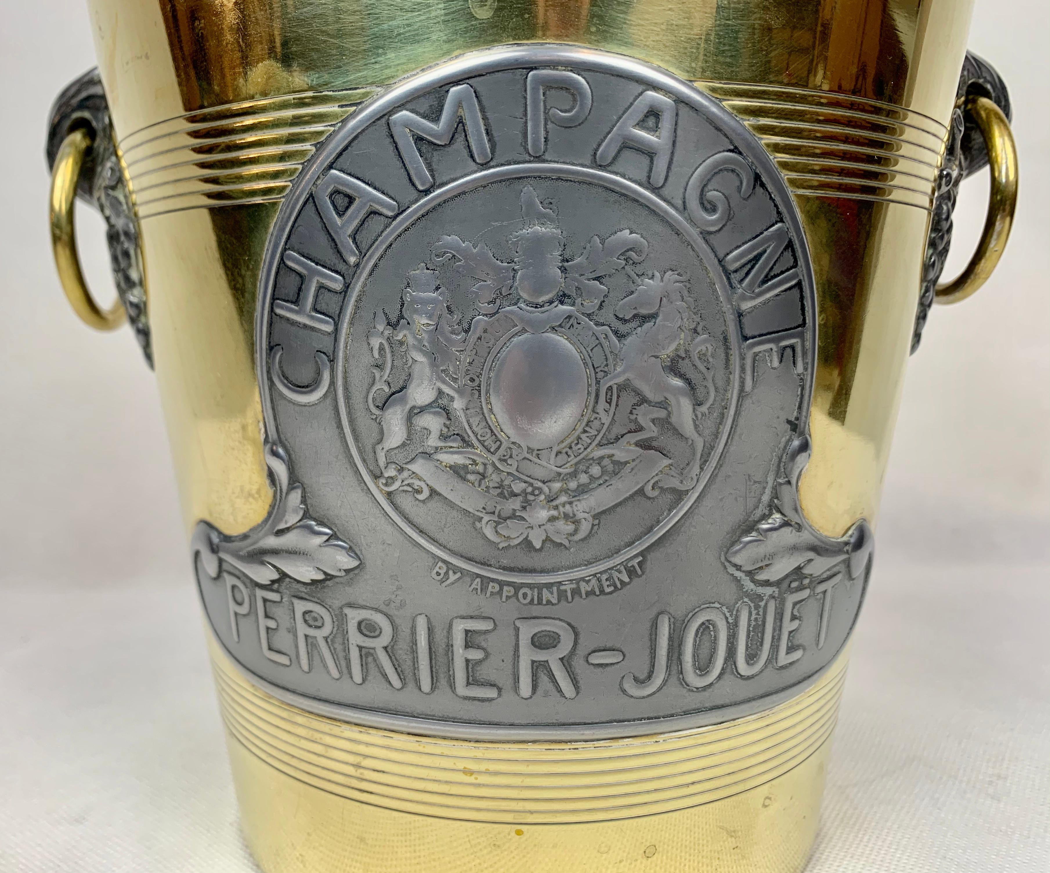 This antique Perrier-Jouet brass and pewter champagne cooler was made early in the twentieth century by Argit in Paris (makers mark on the bottom). The front has in pewter 
