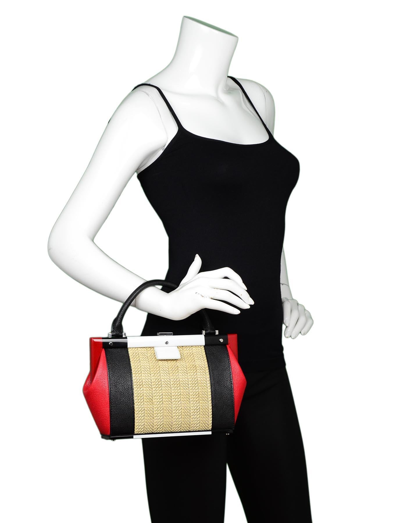 Perrin Black/Red/White Calfskin Leather/Raffia Le Bavolet Top Handle Frame Bag

Color: Black, red, white, tan
Hardware: Silvertone
Materials: Calfskin leather, raffia, metal
Lining: White leather 
Closure/Opening: Frame style with clasp