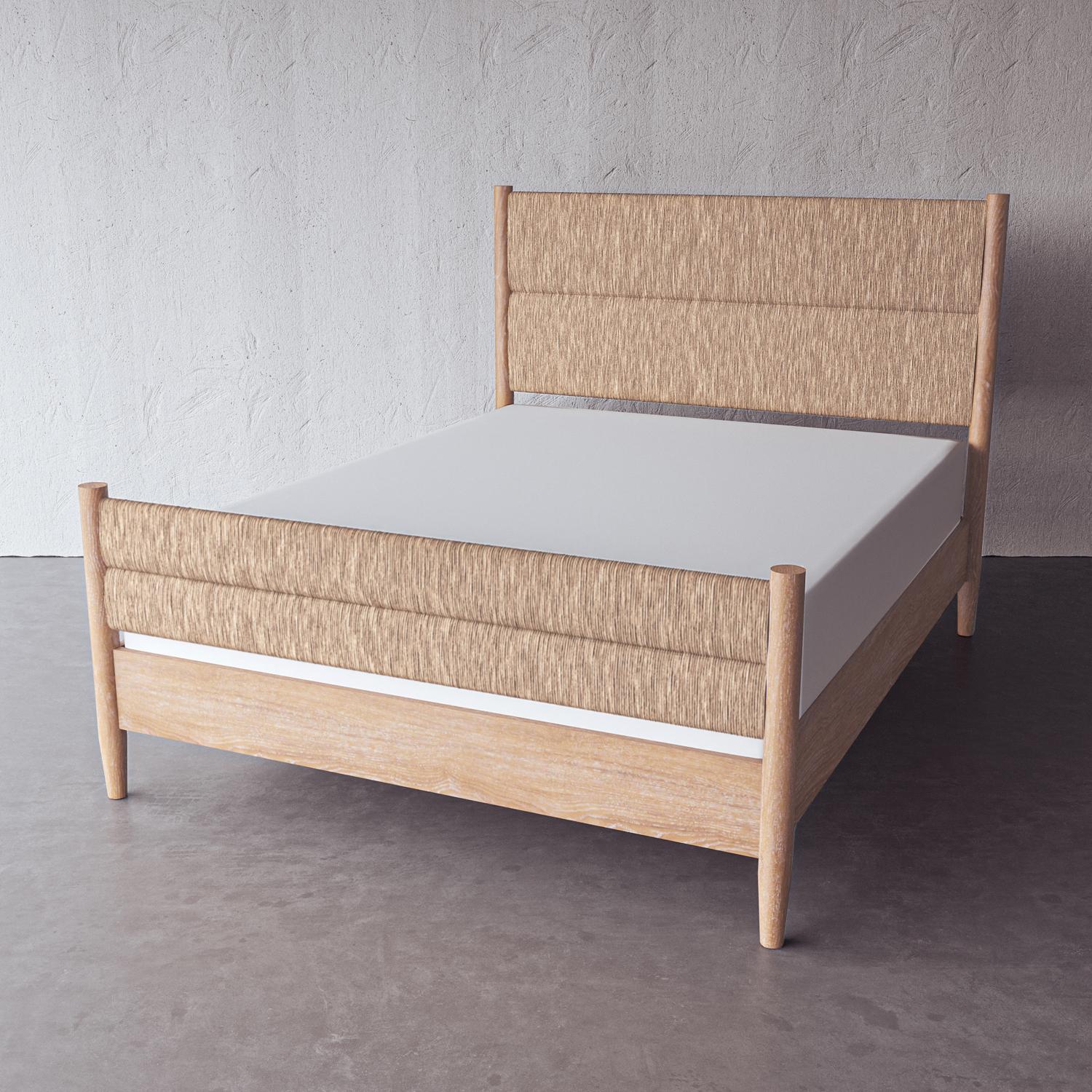 Architectural rush weaves between clean, simple posts to make a textural headboard and footboard on this cerused European oak bed frame. Handmade by artisans in Vietnam, this piece is available in a queen and king size.