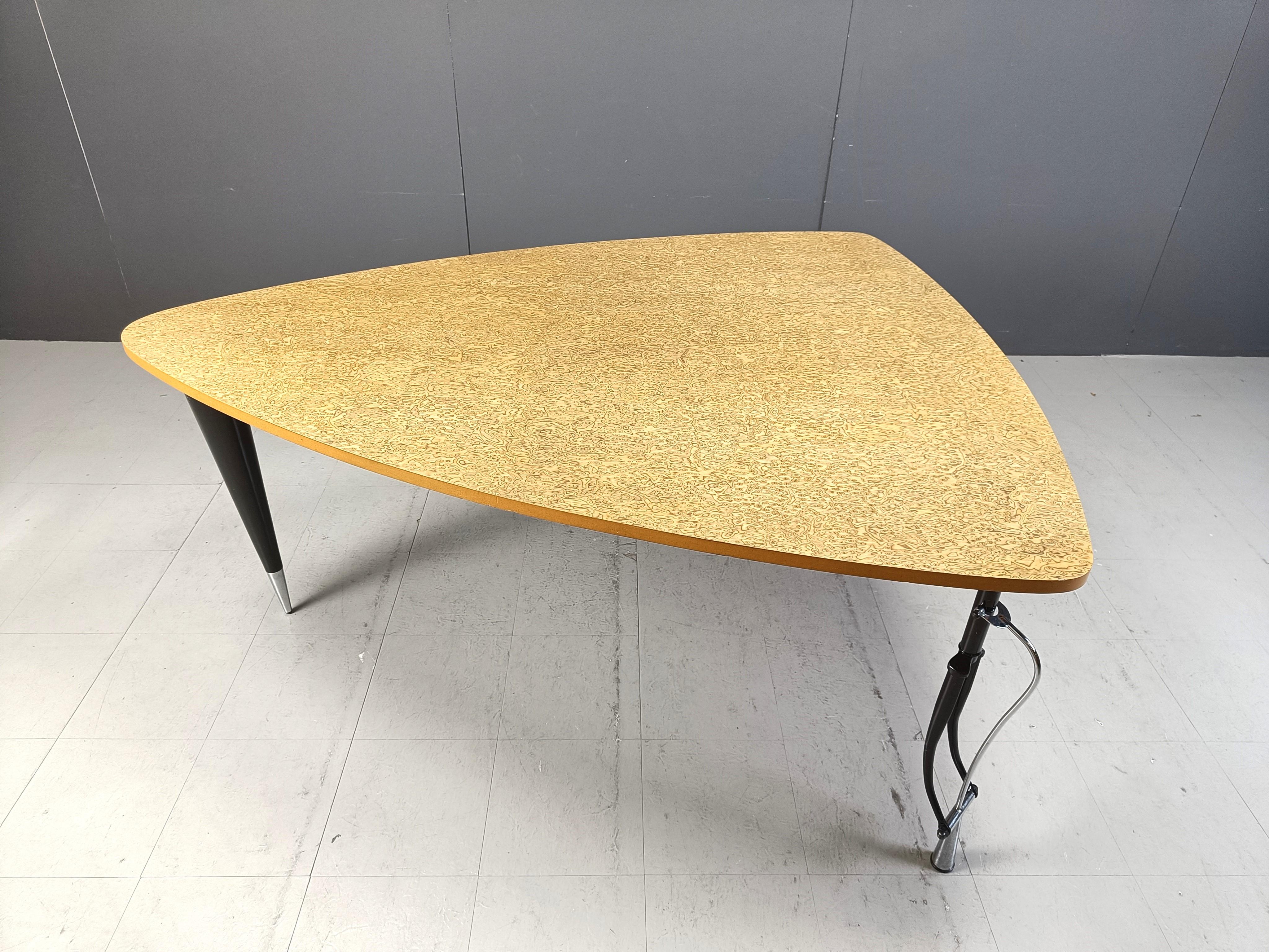 ‘La Vuelta’ dining table designed by Perry King & Santiago Miranda for Akaba in the late 1980s. This Model is called “La Vuelta” after the Spanish bicycle race course.

The table has a frame in black painted and chromed metal, with two legs made of