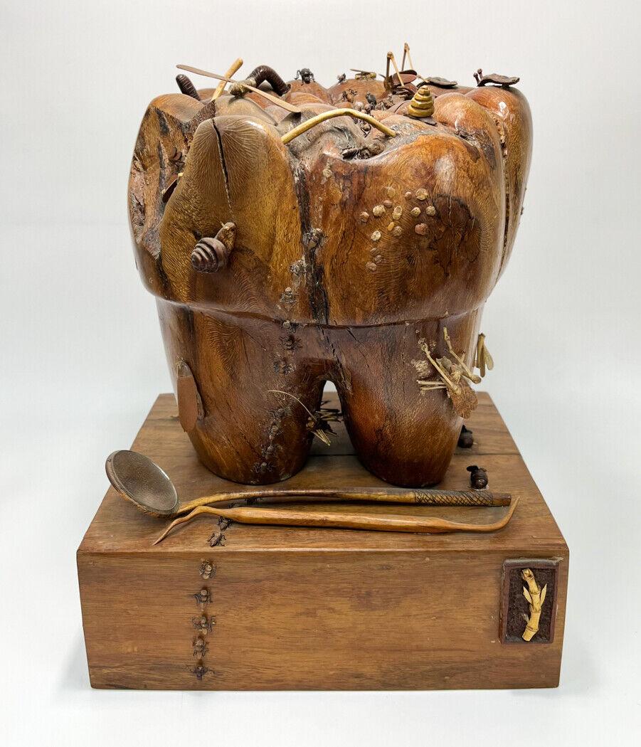  Tooth with Insects by Perry Policicchio (born 1960), Hawaiian, whimsical large carved molar embellished with snails, worms, grasshoppers, ants and other insects in carved wood and bamboo, all on a rectangular base with applied dental tools, signed