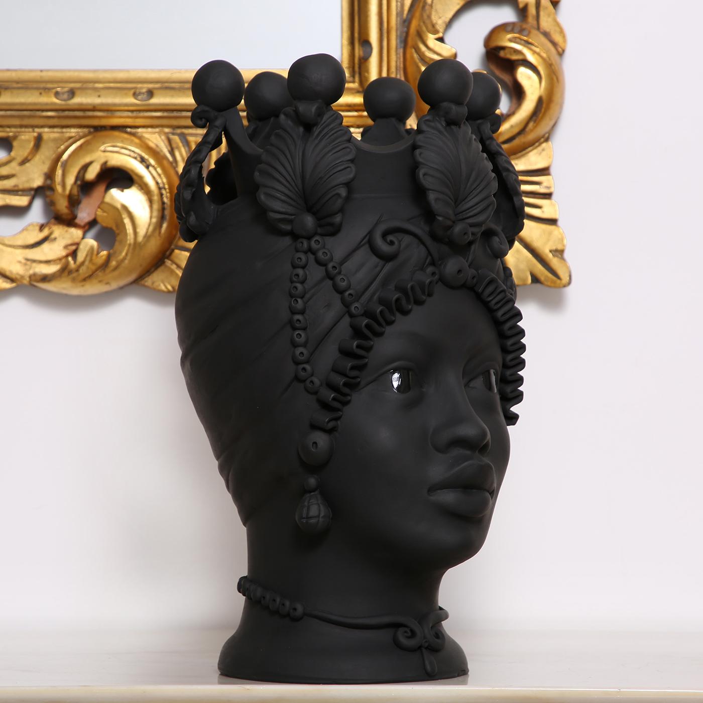 Meticulously handcrafted by ceramicist Stefania Boemi, this anthropomorphic vase of the Greek goddess Persephone is a testament to ancient crafting traditions. Crafted of terracotta with a rich matte black glaze, the vase delicately represents the