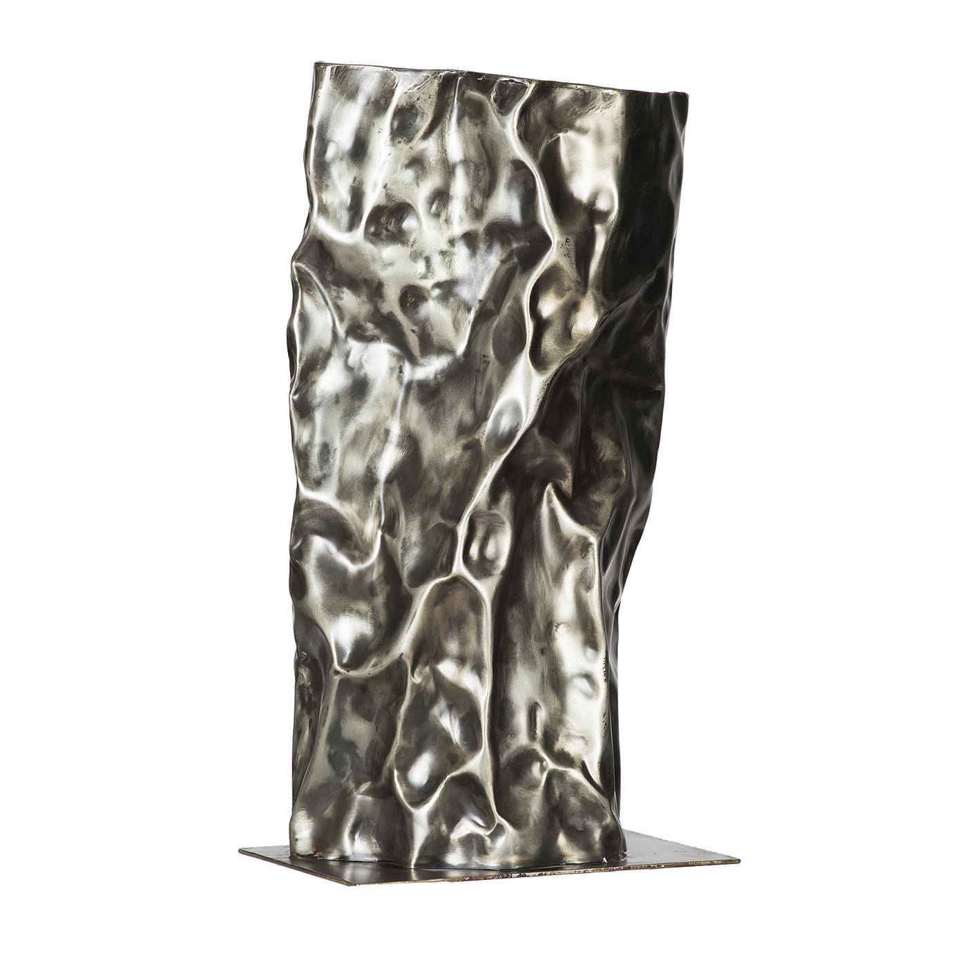 Bold and solid, this extraordinary sculpture is a glorious showcase of craftsmanship. Handmade of iron, it is heated several times and shaped with a hammer. It combines two different textures: small, square tiles on the bust, and a smooth laminate