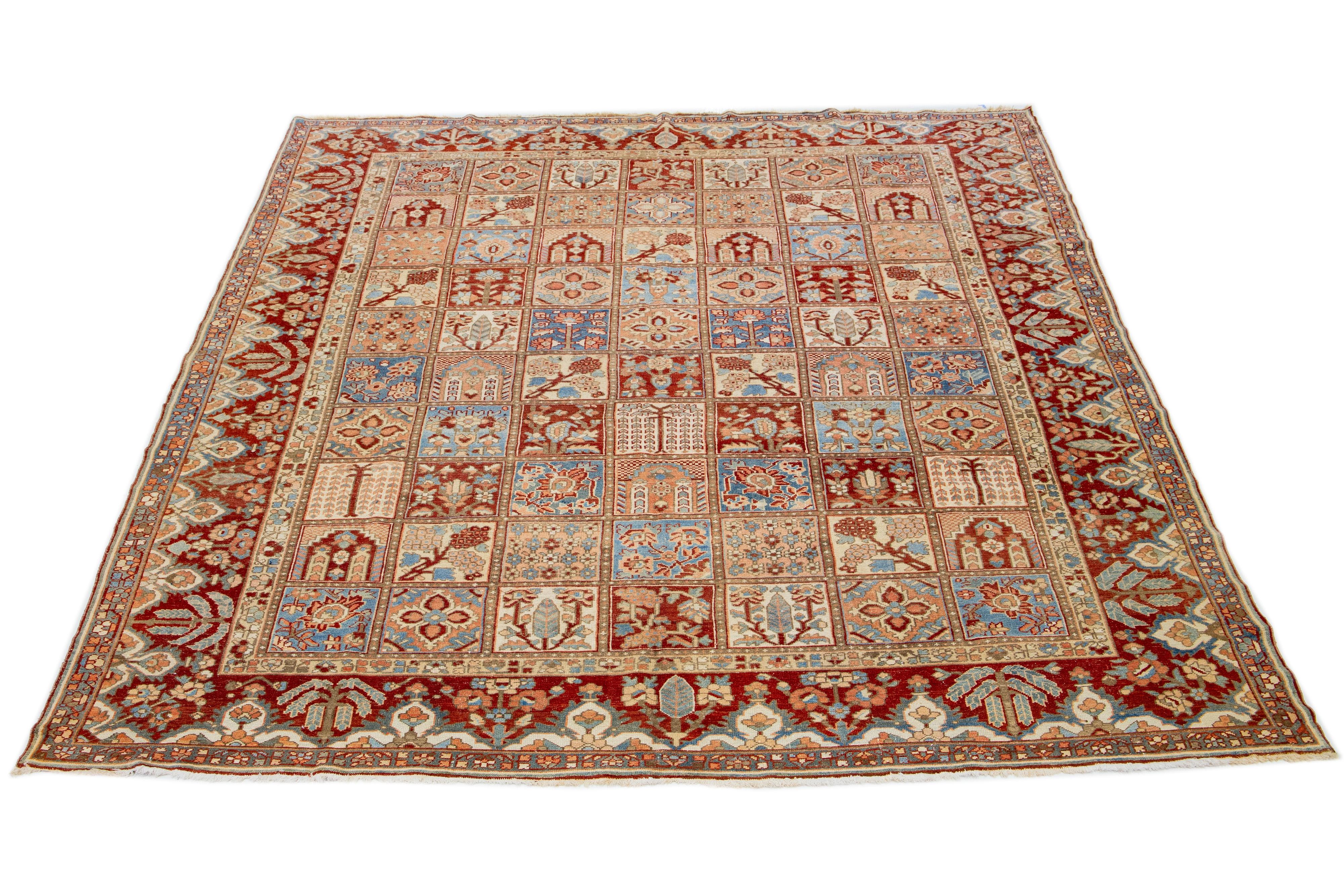 Beautiful Antique Bakhtiari hand-knotted wool rug with a red-rust, blue, beige, and peach color field. This Persian piece has a classic floral pattern.

This rug measures 11' x 13'3