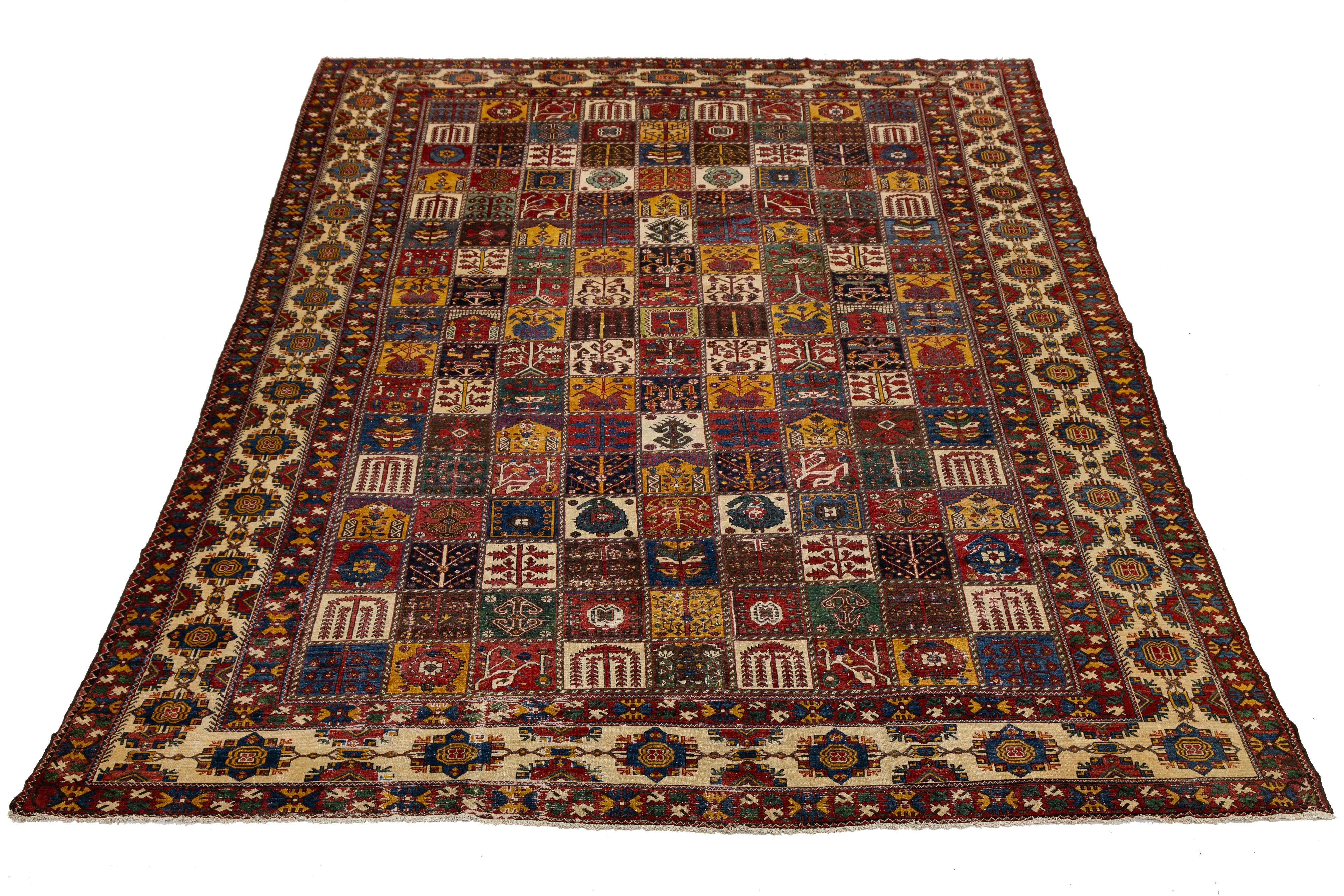 This stunning antique Bakhtiari rug, hand-knotted from wool, features a rich color palette of red-rust, blue, beige, and yellow. Adorned with a timeless floral design, this Persian piece showcases exquisite craftsmanship and beauty.

This rug