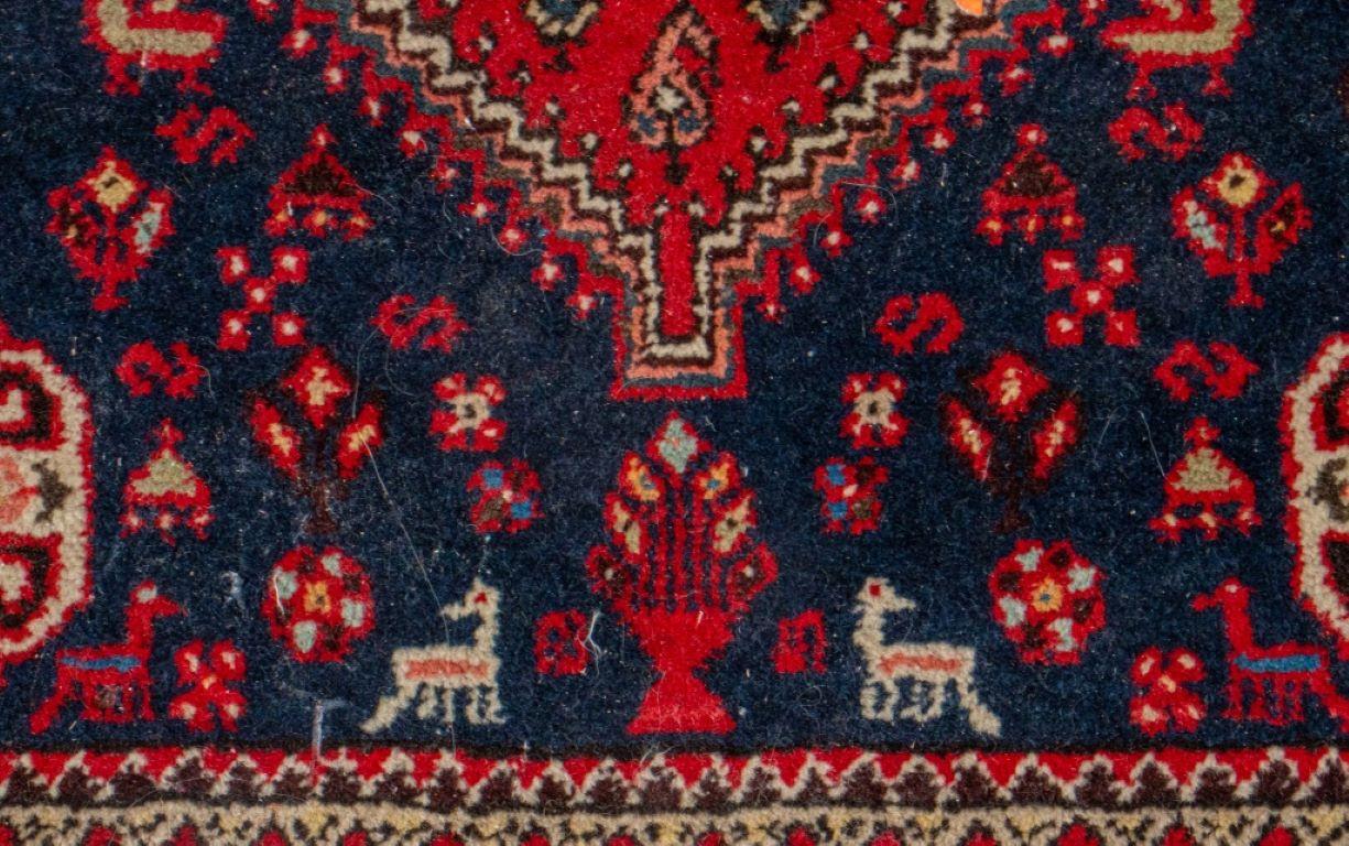 Persian hand-woven abadeh carpet with a central geometric medallion surrounded by animal figures on a red ground.

Dealer: S138XX