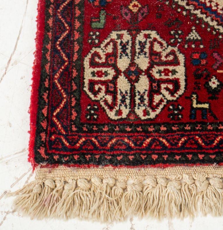 Persian hand-woven abadeh carpet with a central medallion and geometric designs on a red ground. 

Dealer: S138XX