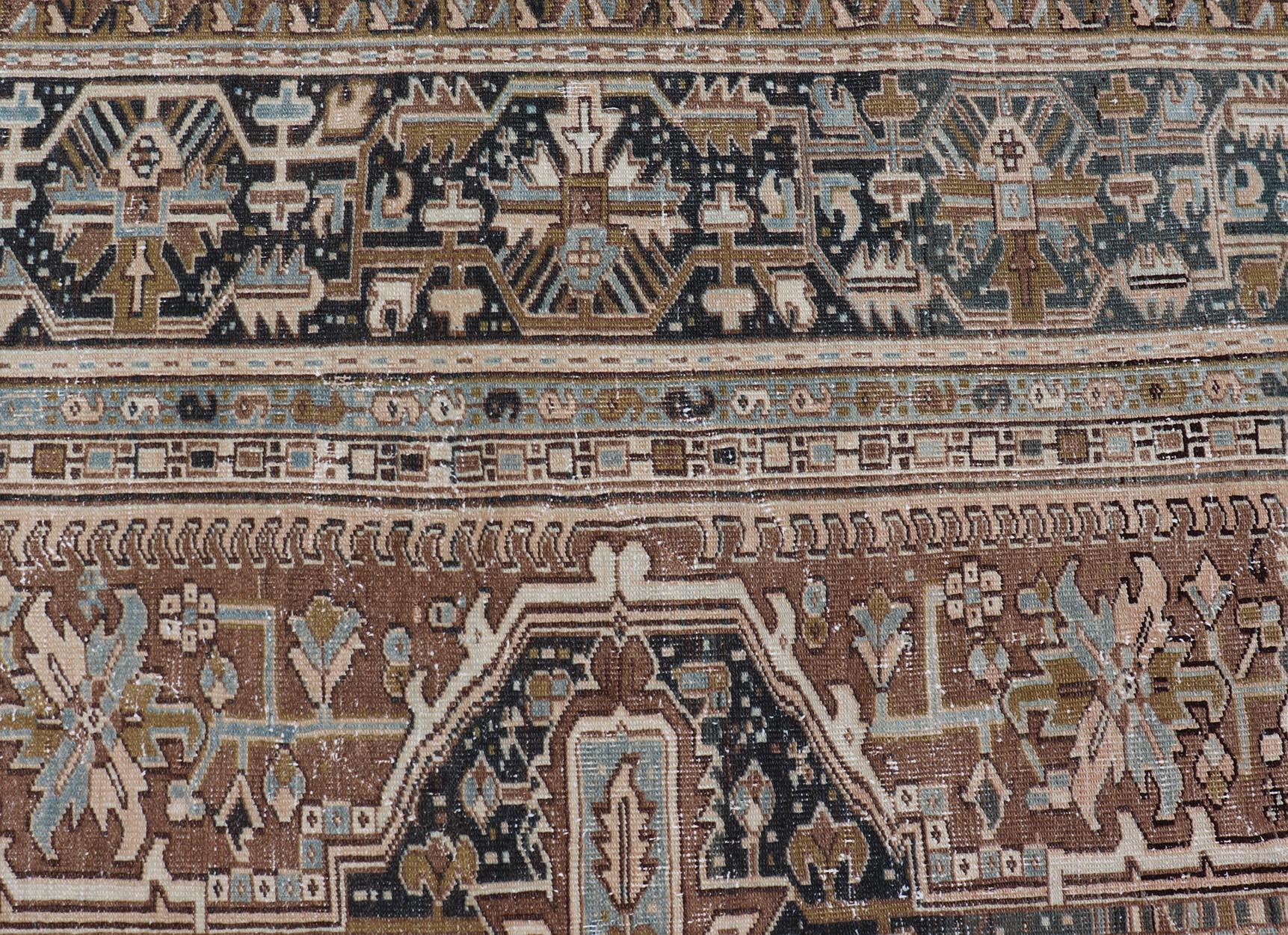 Persian Antique Heriz Rug with Geometric Design in Blue's, Tan, Cream, and Brown. Keivan Woven Arts / rug V21-0120, country of origin / type: Iran / Heriz, circa 1930
Measures: 11'5 x 14'7
This magnificent Persian Heriz carpet bears an exquisite
