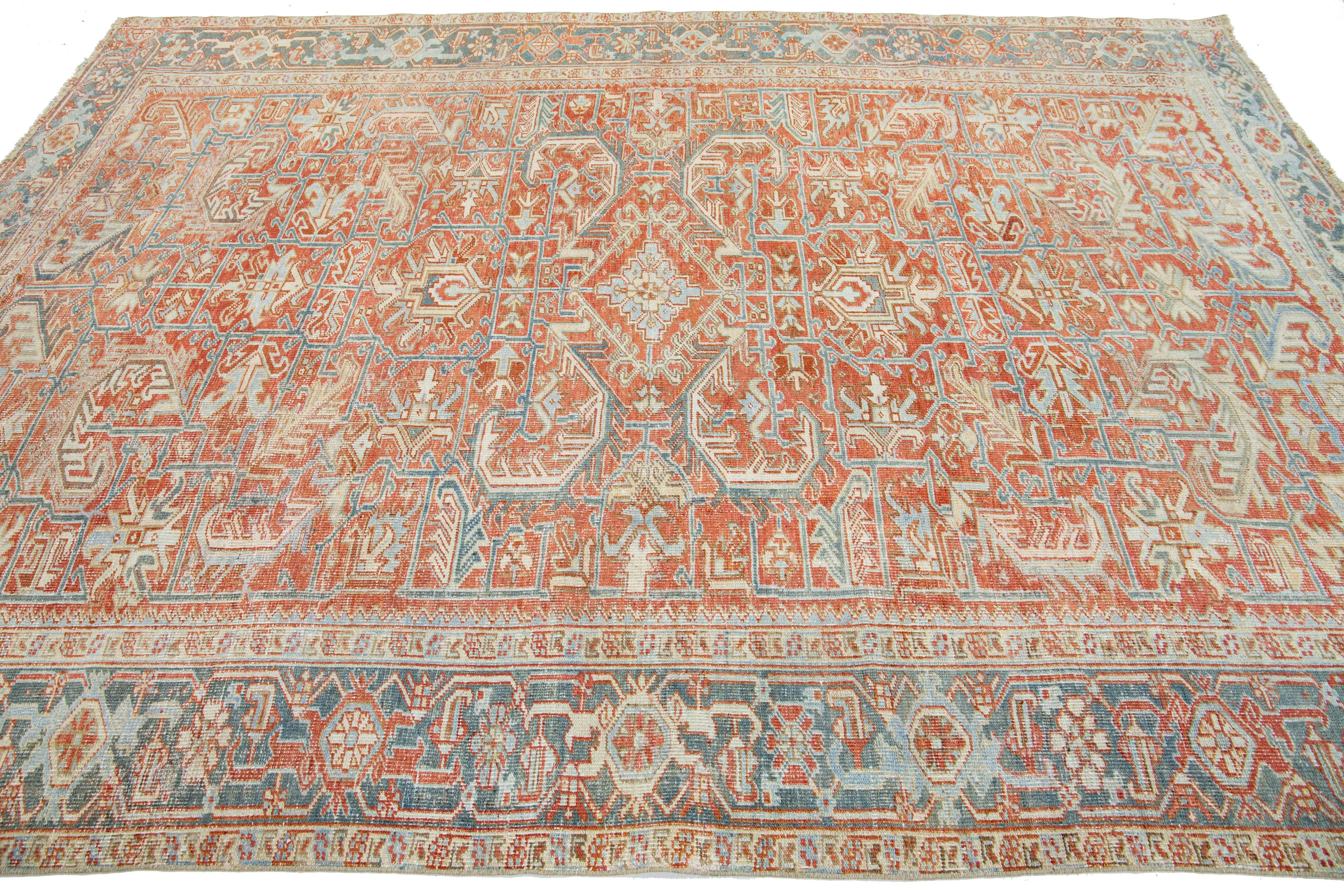 Hand-Knotted Persian Antique Heriz Wool Rug with an Allover Design Featuring Rust Color Field For Sale