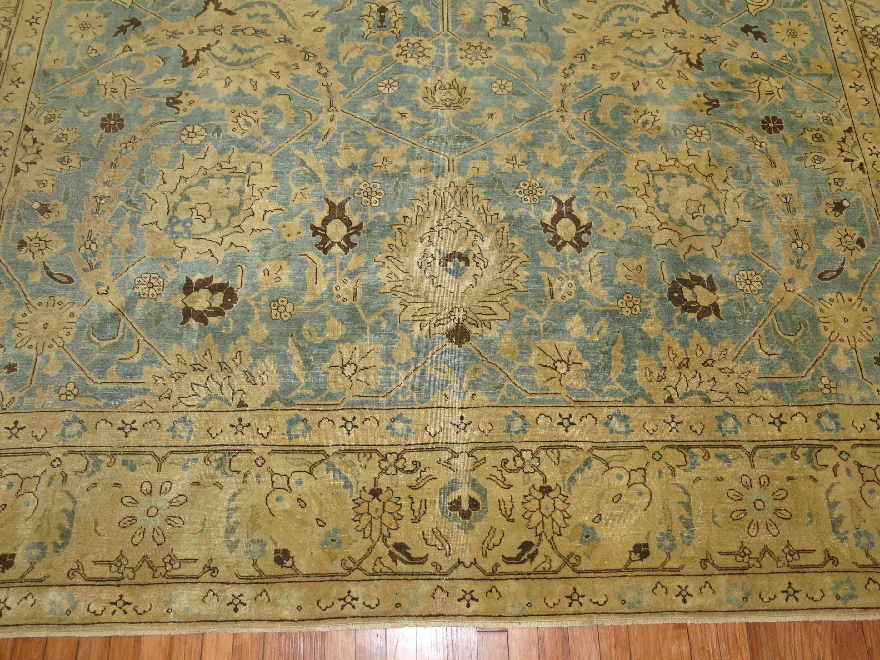An early 20th century antique Persian Tabriz rug. Powder sky blue field, gold/yellow accents.

9'11'' x 12'10''

Tabriz rug weavers drew on a varied repertoire of delicate designs: multi-faceted flowerheads, subtle arabesques, lush vinery rendered