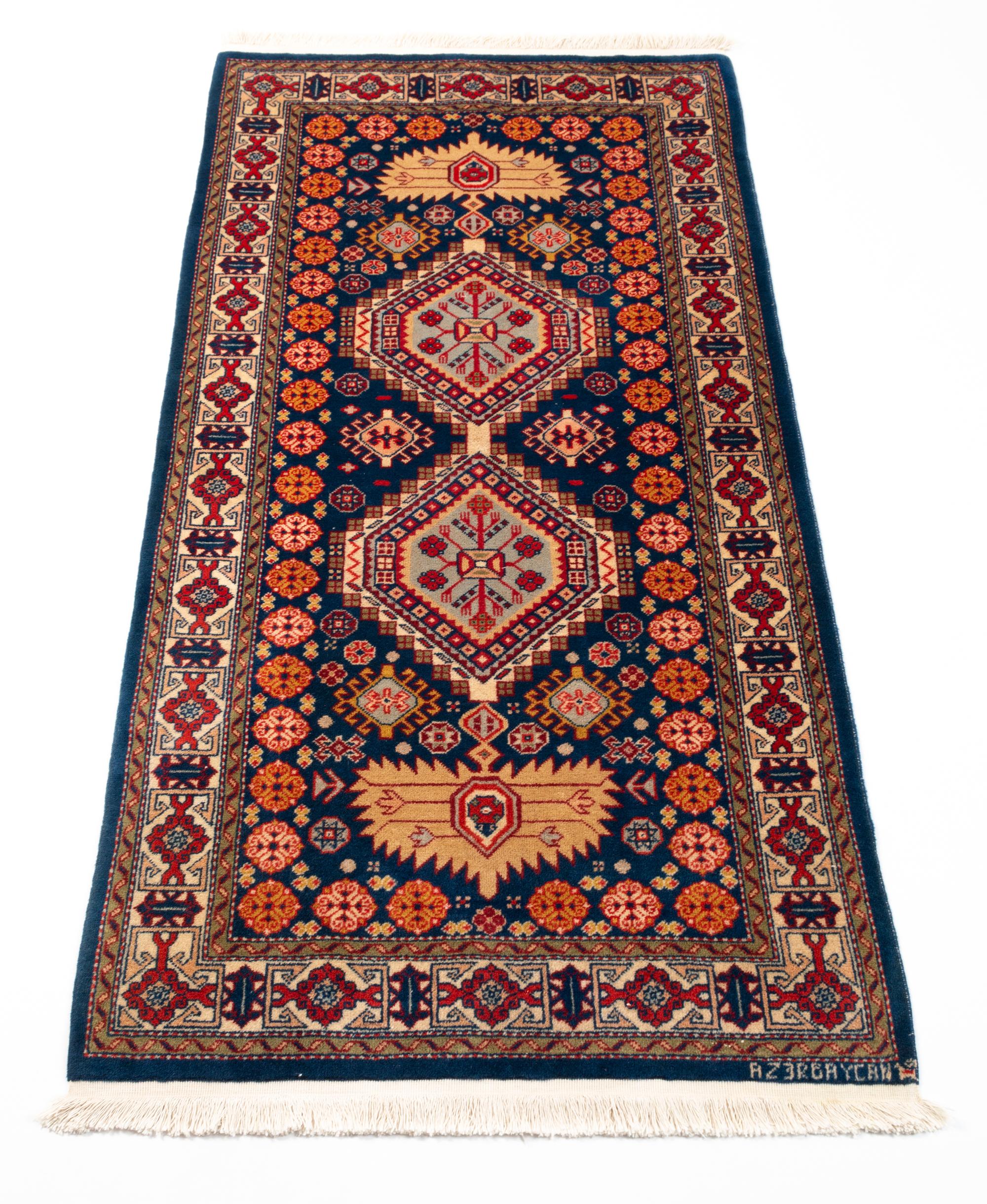 Azerbaijani hand-knotted rug runner geometric design
Wool on a cotton foundation

Measures: 75 x 155 cm 

Produced in Azerbaijan in the mountain chain of Caucasus.
Imaginative geometrical patterns 
Excellent condition.

