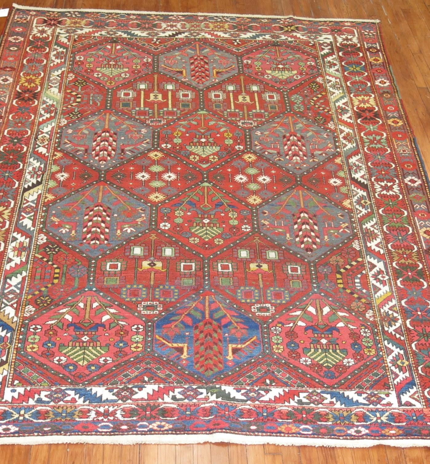 An early 20th century Persian Bakhtiari rug with a large scale repetitive pattern on a brown-red field

Measures: 7'1'' x 9'7''.