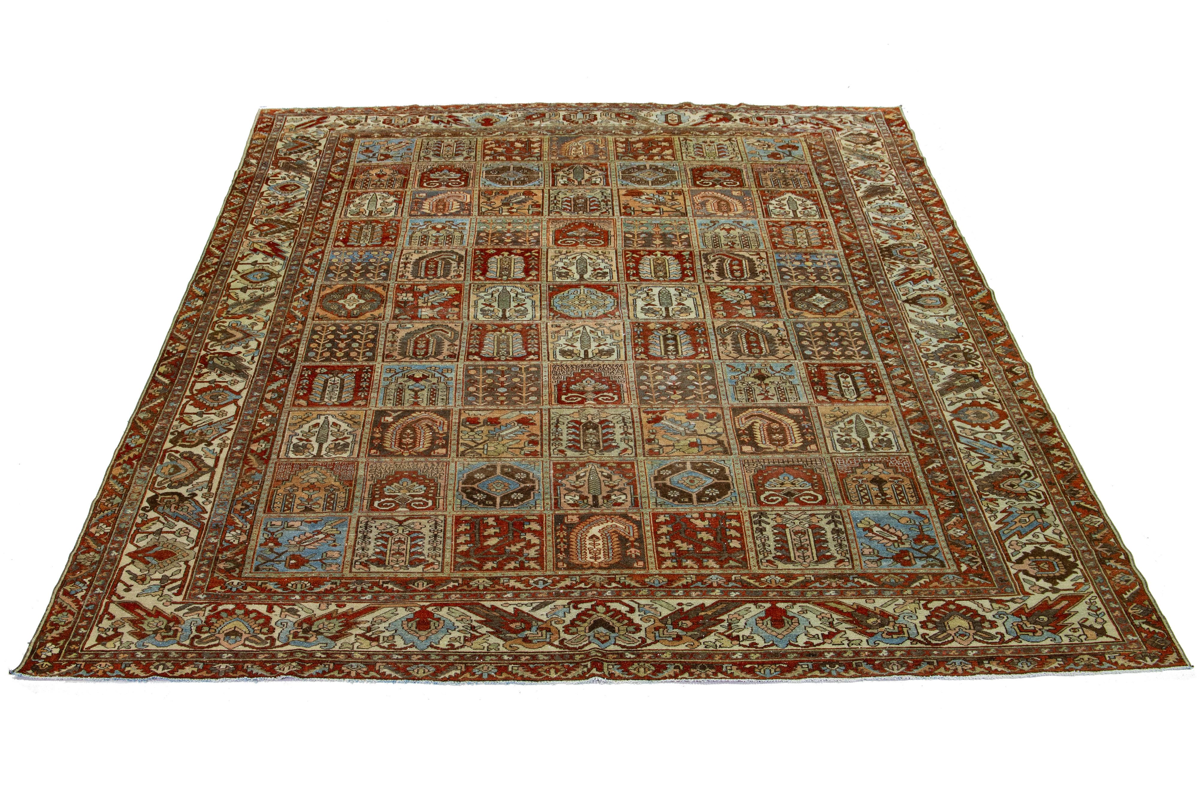 Beautiful Antique Bakhtiari hand-knotted wool rug with a blue, red-rust, beige, and peach color field. This Persian piece has an all-over geometric floral design.

This rug measures 10'6