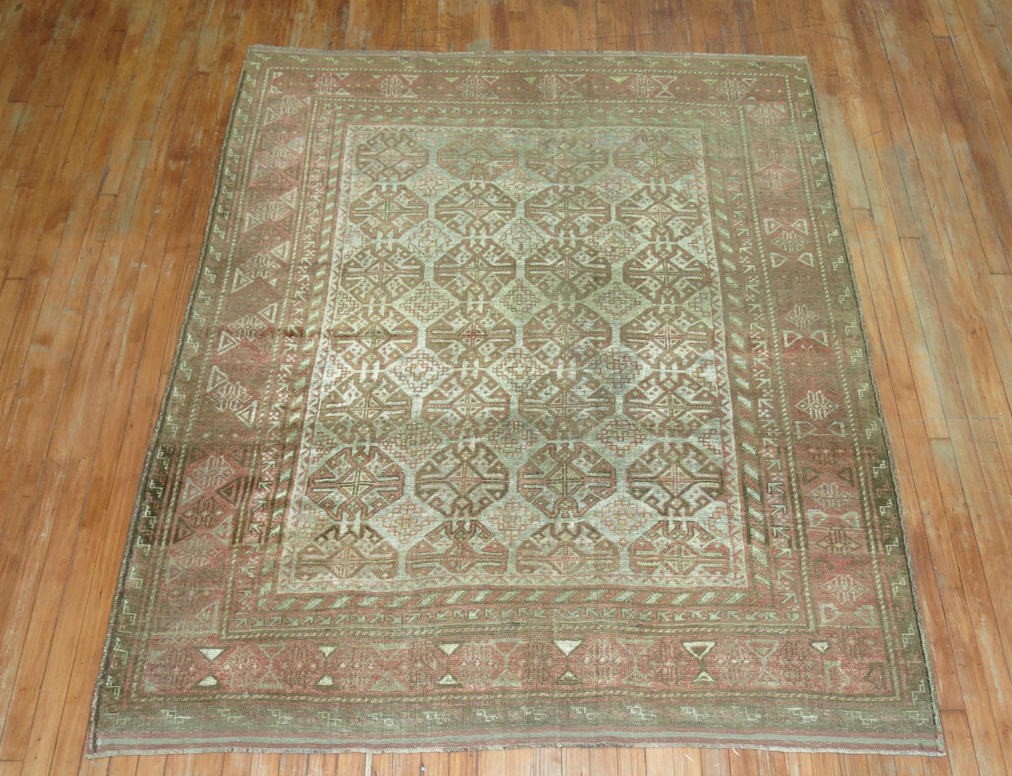 Pale brown, terracotta, soft blue and caramel Persian Balouch carpet from the early 20th century.