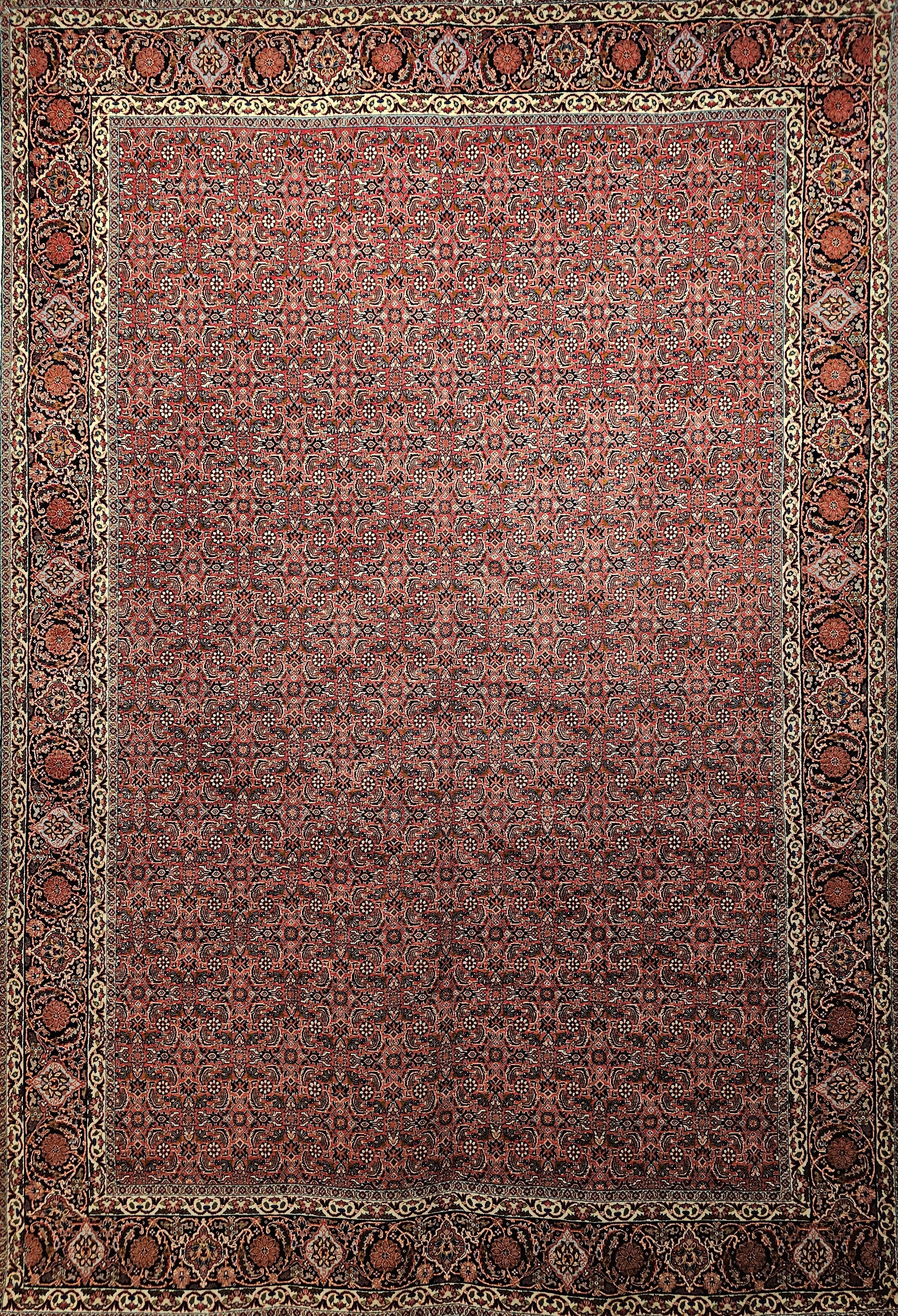  A Hand-Knotted Persian Bidjar in an all over Herati geometric pattern from the late 1900s.  The rug has a red background color with designs in navy blue, ivory, French blue, and yellow.  The border is midnight blue/black background with design