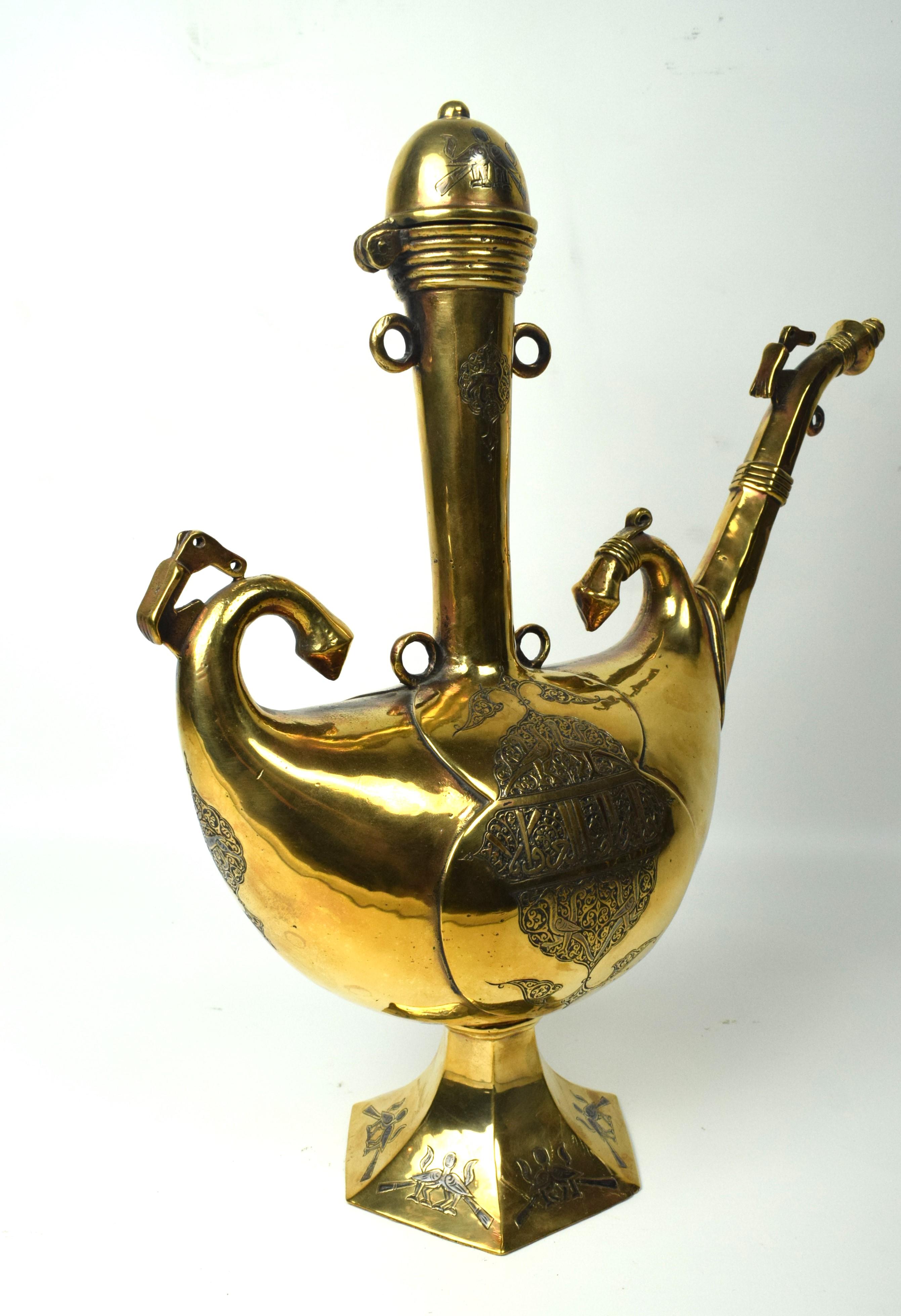 The brass Persian Islamic ewer from the mid-19th century is a stunning example of craftsmanship and artistic expression. This ewer is not only a functional vessel but also a work of art that reflects the cultural and artistic richness of the Islamic