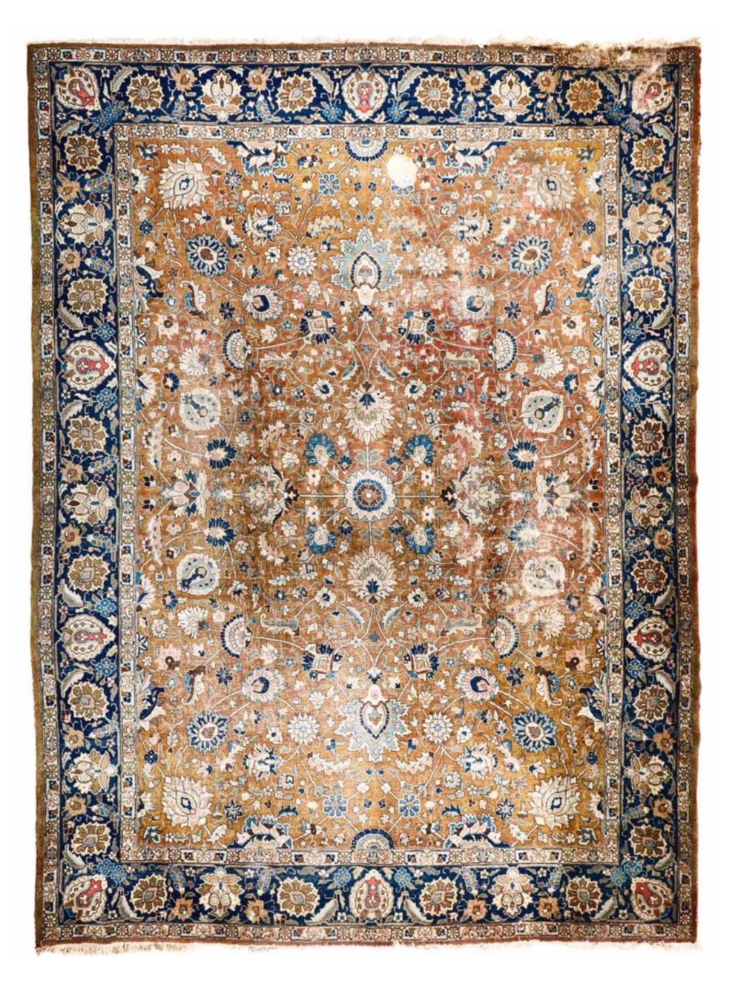 Persian carpet with toffee colored center and large floral pattern.