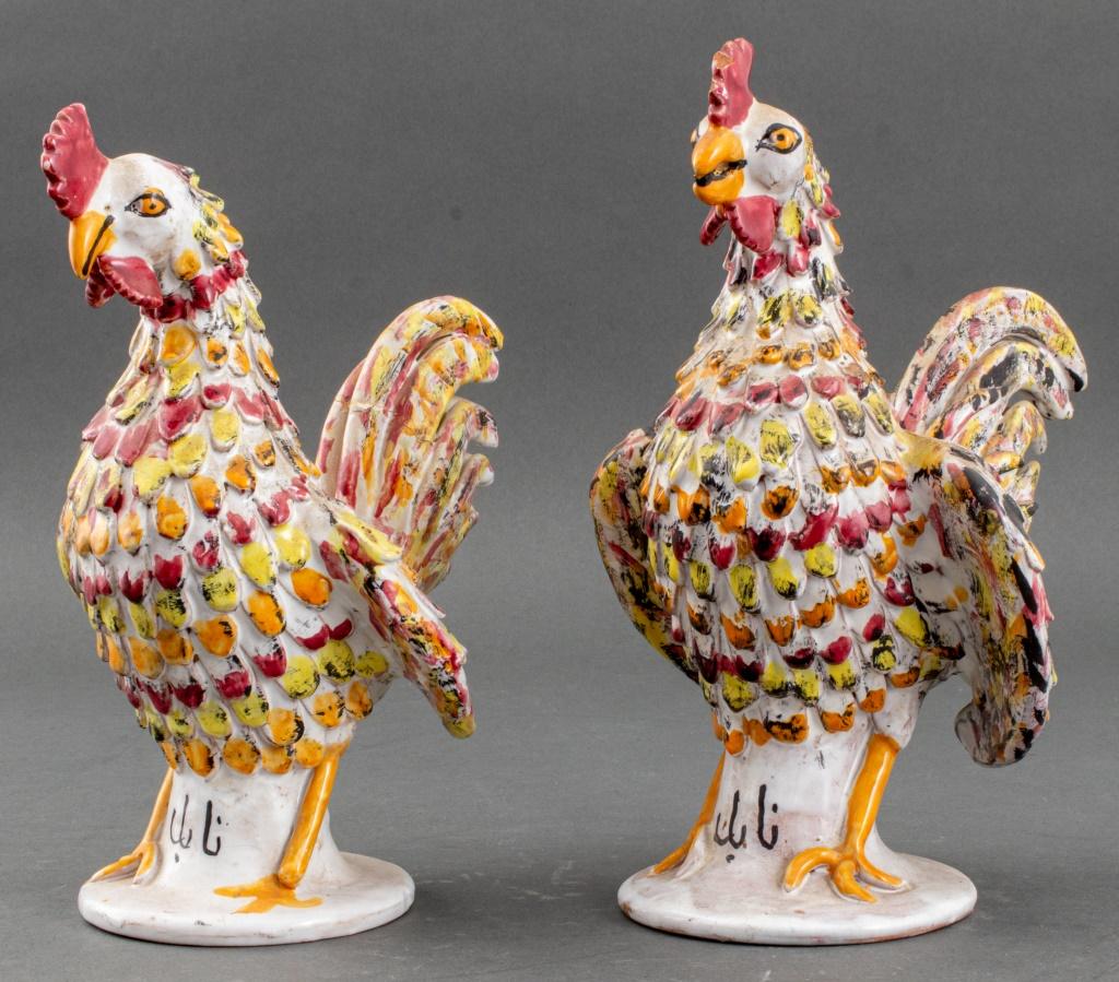 Pair of of Persian ceramic pottery sculptures depicting standing roosters, each polychrome glazed with Arabic writing to base. Old repair to one tail and some chips to glaze.

Dimensions: 11.5