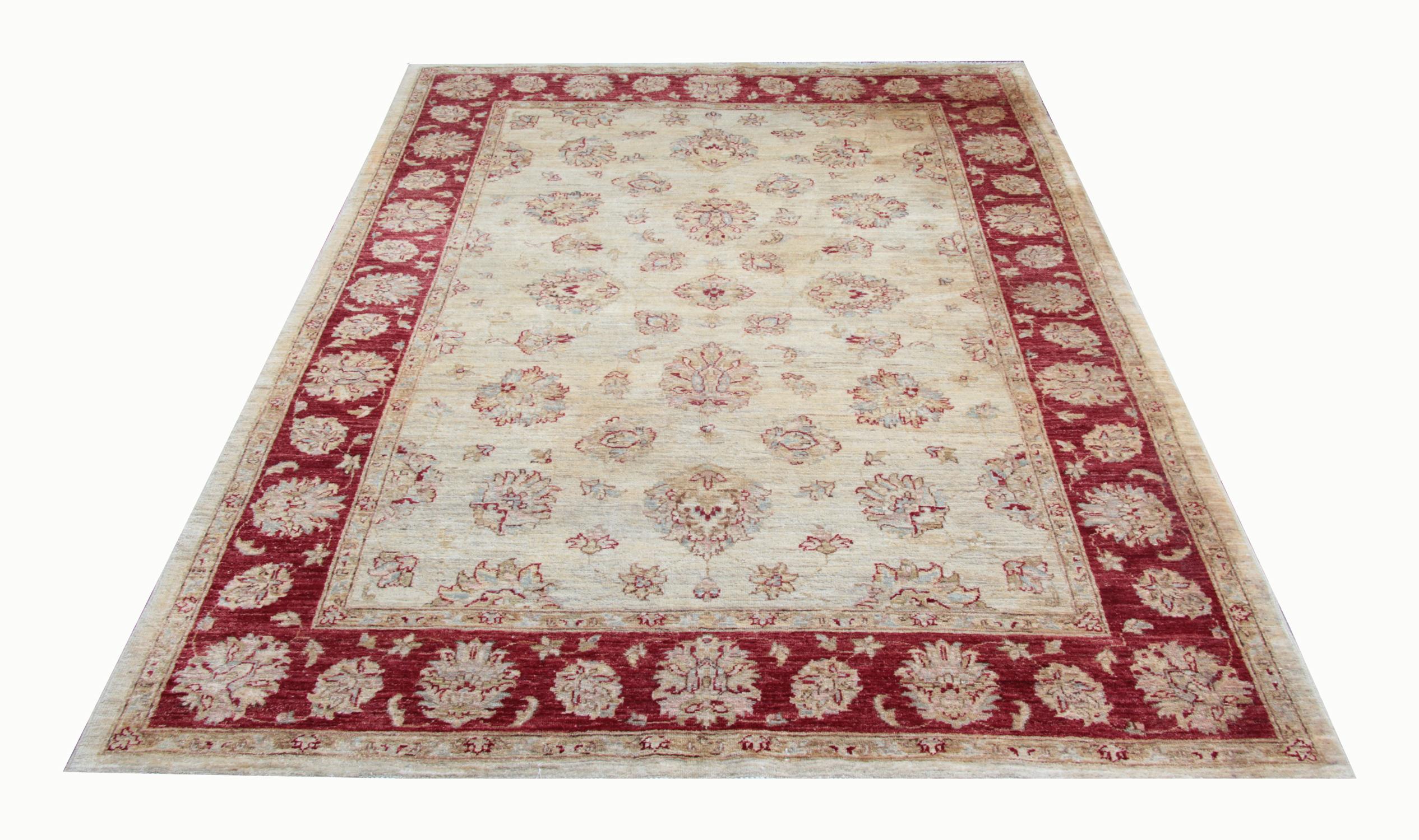 This golden white rug with a magnificent red border is a Ziegler Sultanabad woven rug made on our looms by our master weavers in Afghanistan. These handmade rugs are woven with all natural veg dyes and all handspun wool. The large rug scale design