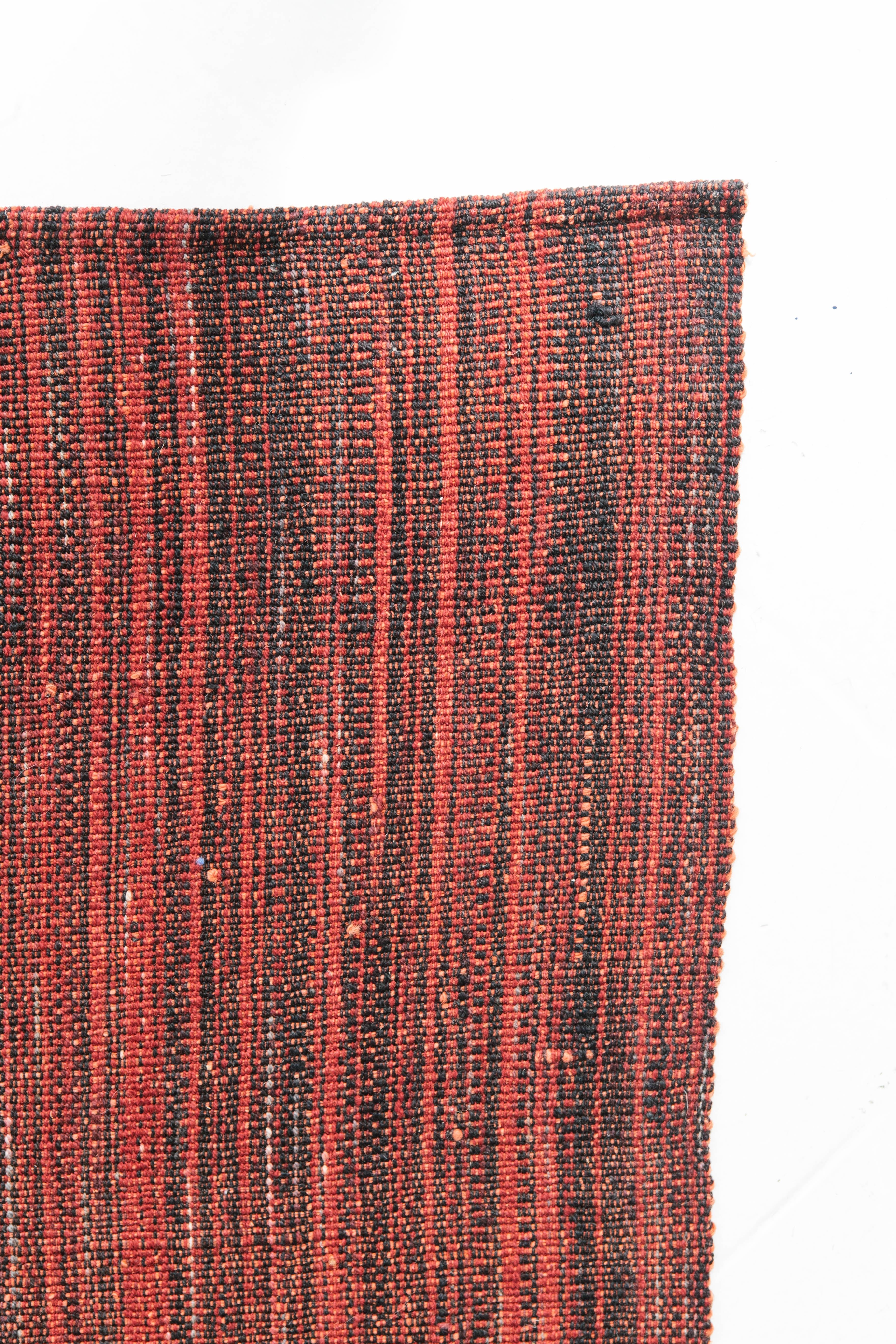 This Persian Edel Kilim flat-weave rug is sophisticated and complicated yet simplistic. A beautiful red and black Kilim that would fit great in a wide variety of interiors. Persian flat weaves are made up of some of the best wool and weaved