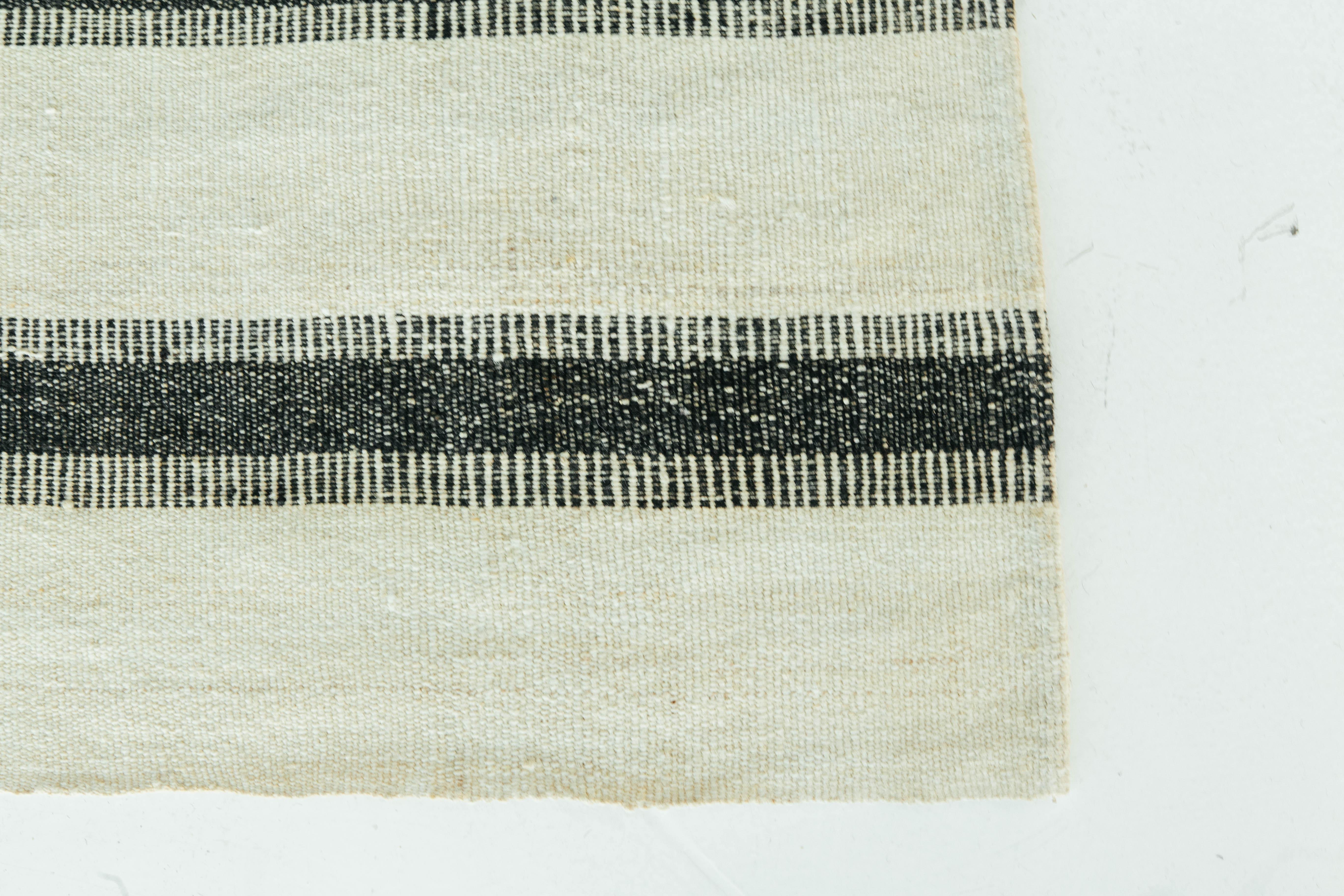 This Persian Jejim Kilim is a banded flat weave with alternating dark brown and ivory colors. The stripes have a unique toothing pattern that adds even more character. Persian flatweaves are made up of some of the best wool and weaved exceptionally