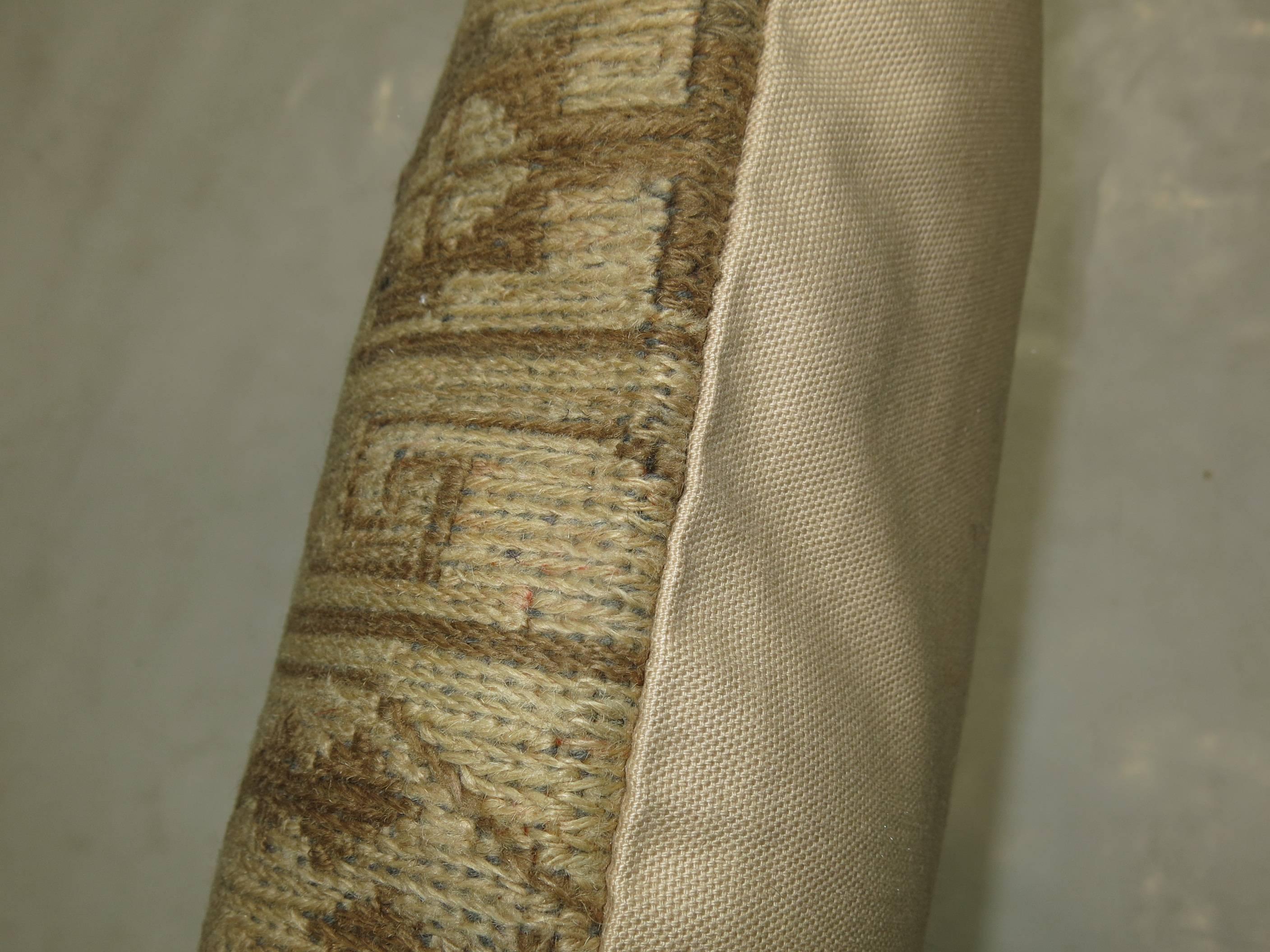 Pillow made from a muted vintage Persian flat-weave rug with pops of light green.

17'' x 17''