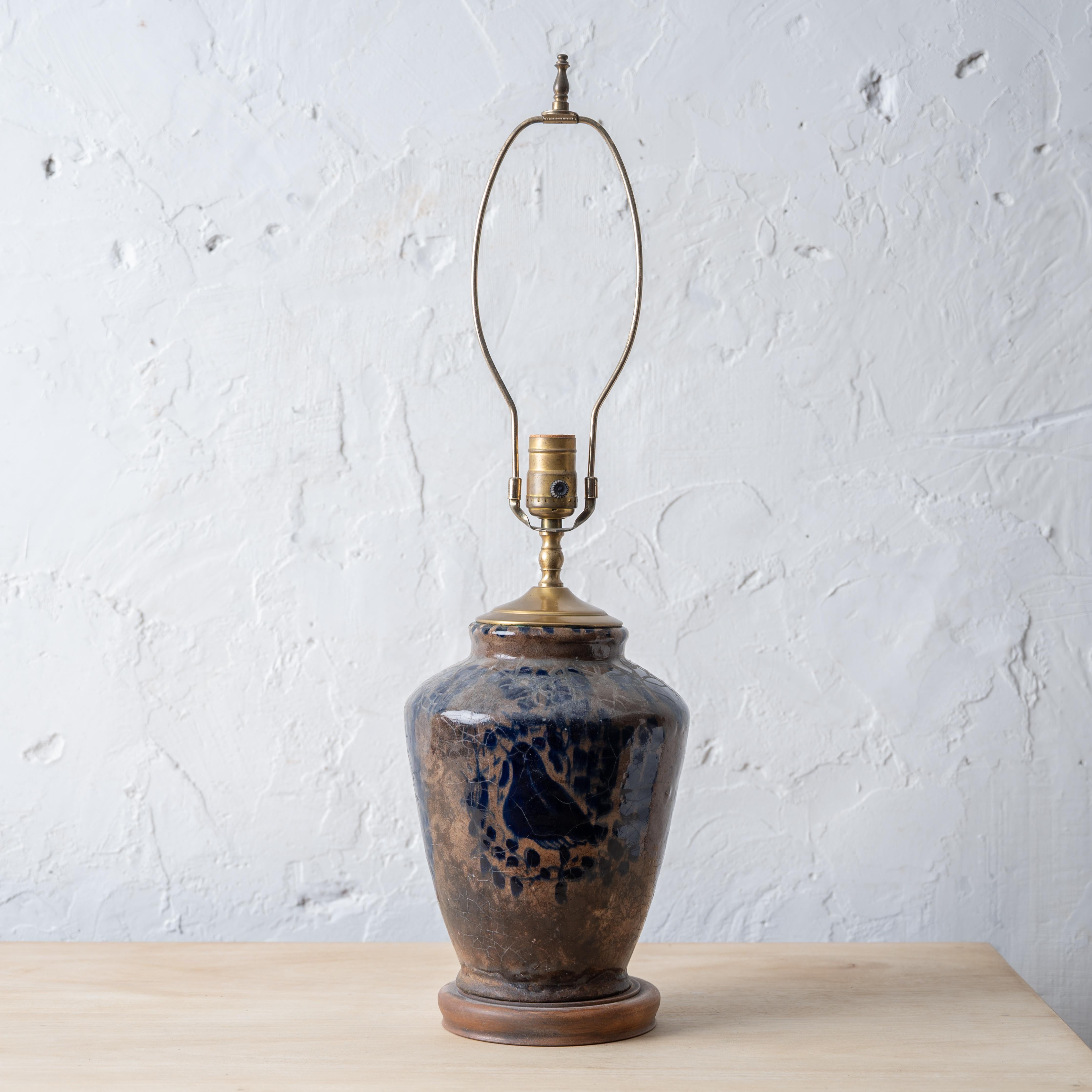 A Persian fritware jar mounted as a lamp, Mamluk period, 16th-17th century.
7 ¾ inches wide by 25 ½ inches tall;

10 ¾ to top of jar



