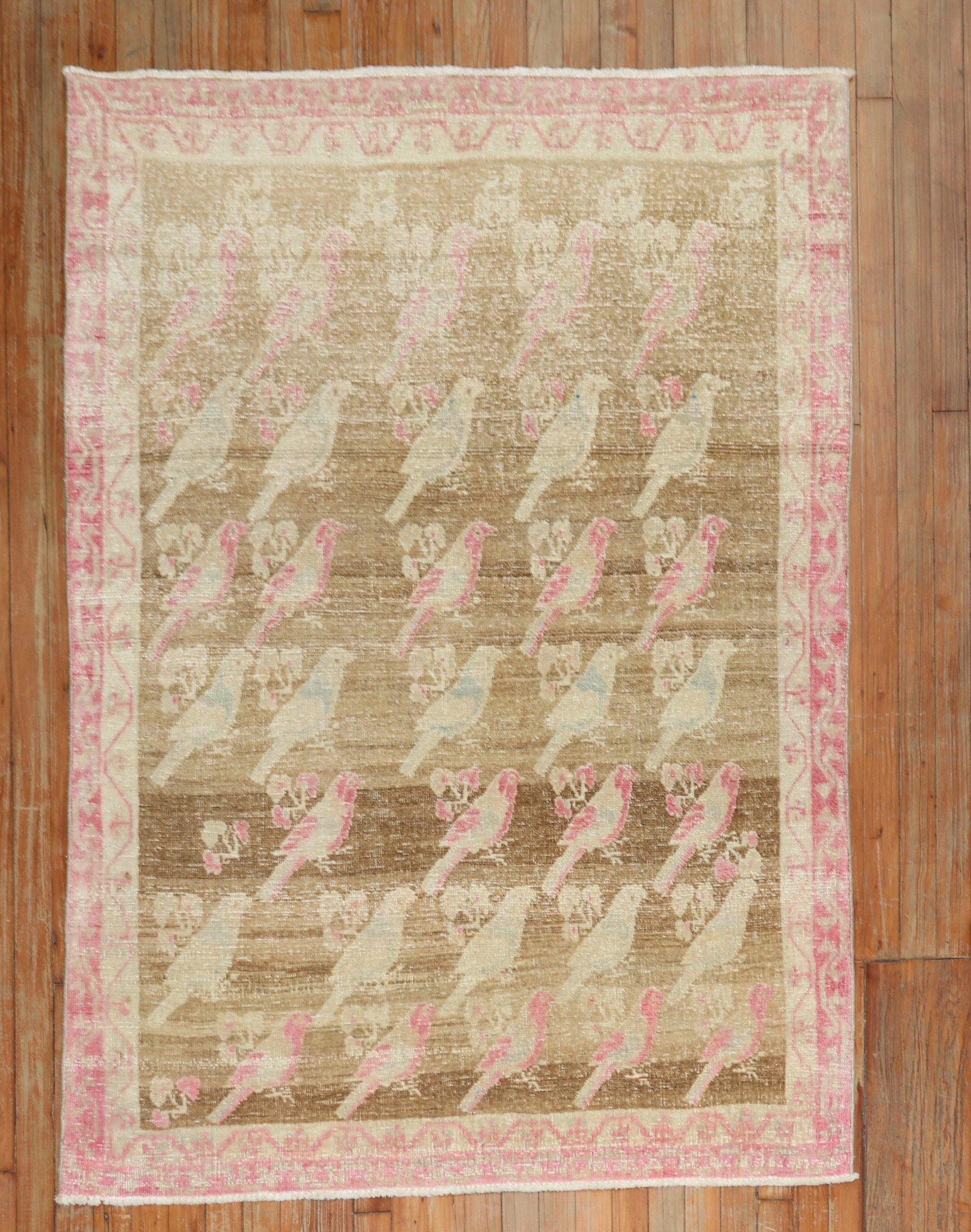 A mid-20th-century worn Persian Gabbeh rug with an all-over pigeon design on a brown field, primary accents in pink

Measures: 4' x 5'11''.