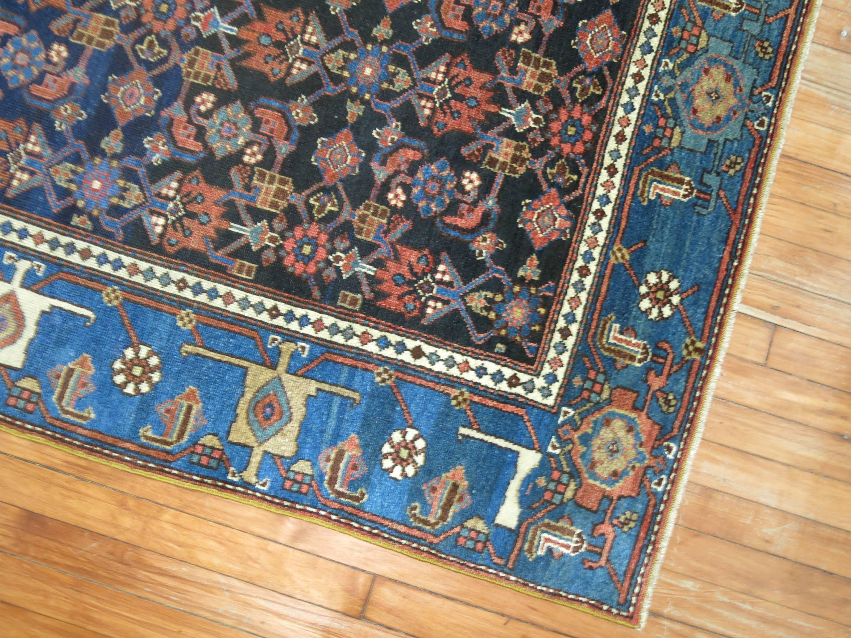 Authentic one of a kind Persian Hamadan rug with navy field and sky blue border.

Hamadan is a major city in Iran that is west of Teheran and north of Malayer and south of the Bijar rug producing areas. Hamadan rugs typically have one heavy cotton