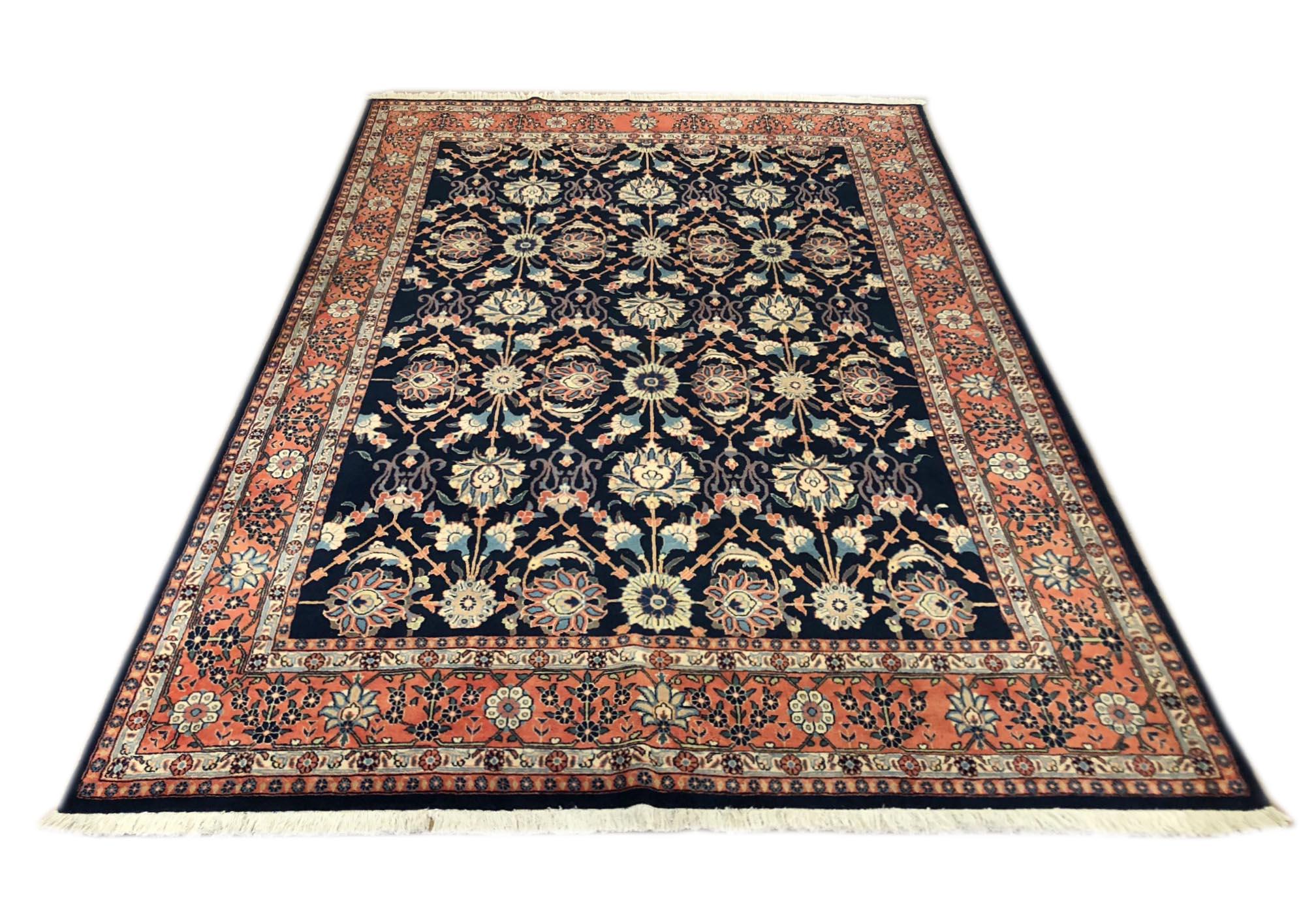 This Mahal rug stands as an incredibly vibrant and descriptive carpet and has wool pile with cotton foundation. The base color is dark blue and the border is salmon color. The size is 6 feet 7 inch by 9 feet 3 inches. This piece compliments your