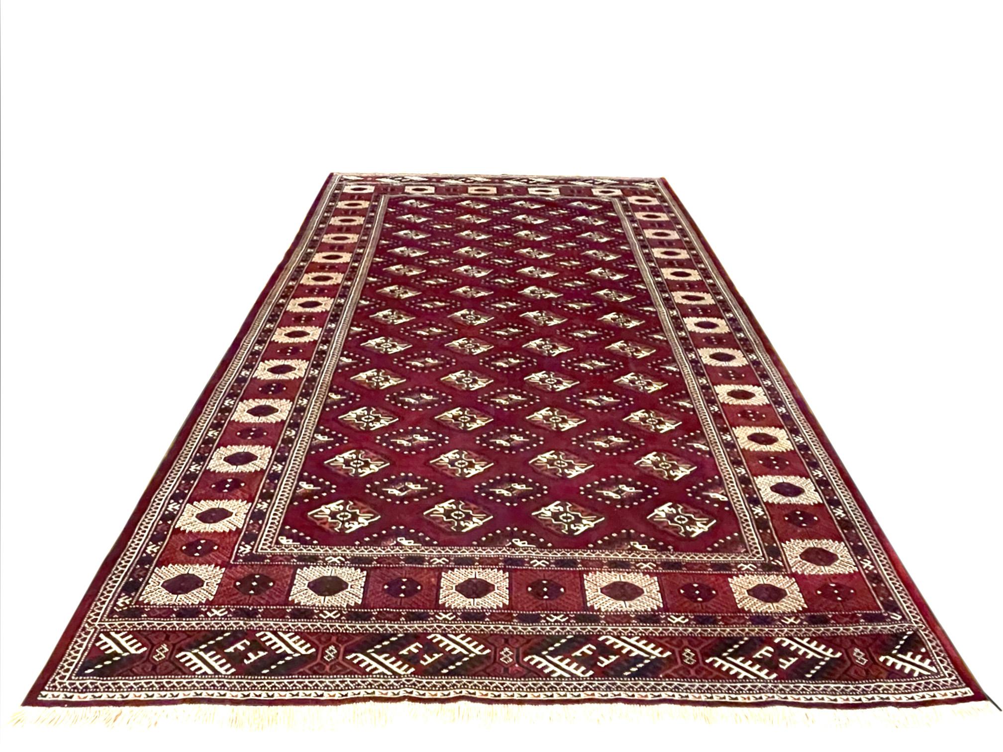 The Turkmen tribes live in the north and north-east of Iran; Turkmen rugs are very distinctive dominated with red colors. This piece is a Persian hand knotted Turkmen rug has wool pile and cotton foundation with geometric – elephant print design.
