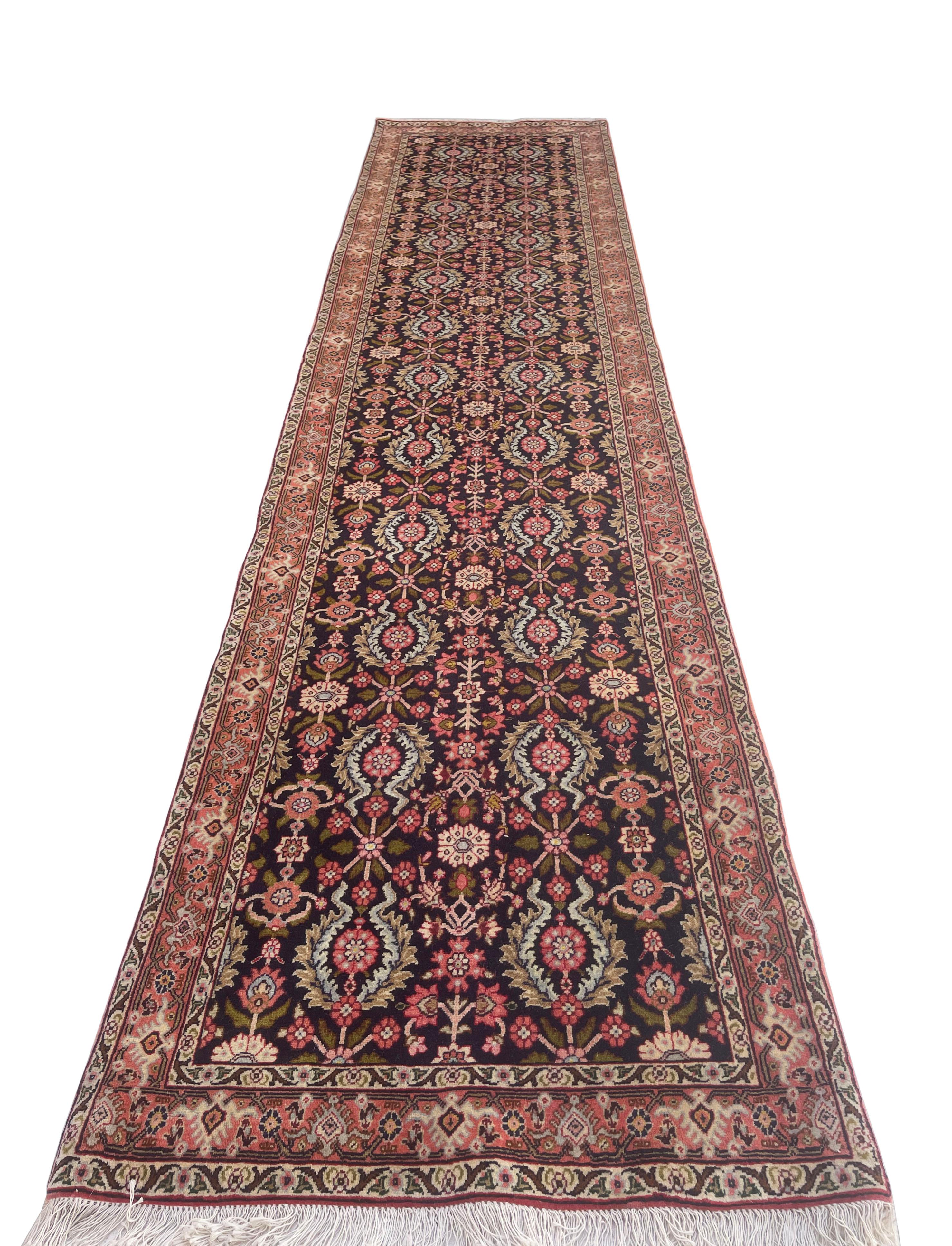 This authentic beautiful over-sized Bijar runner has wool pile and cotton foundation. The rug has repeated all over floral design. The color combination in this piece is dark blue, salmon, cream and green. The size is 2 feet 9 inch wide by 12 feet 4