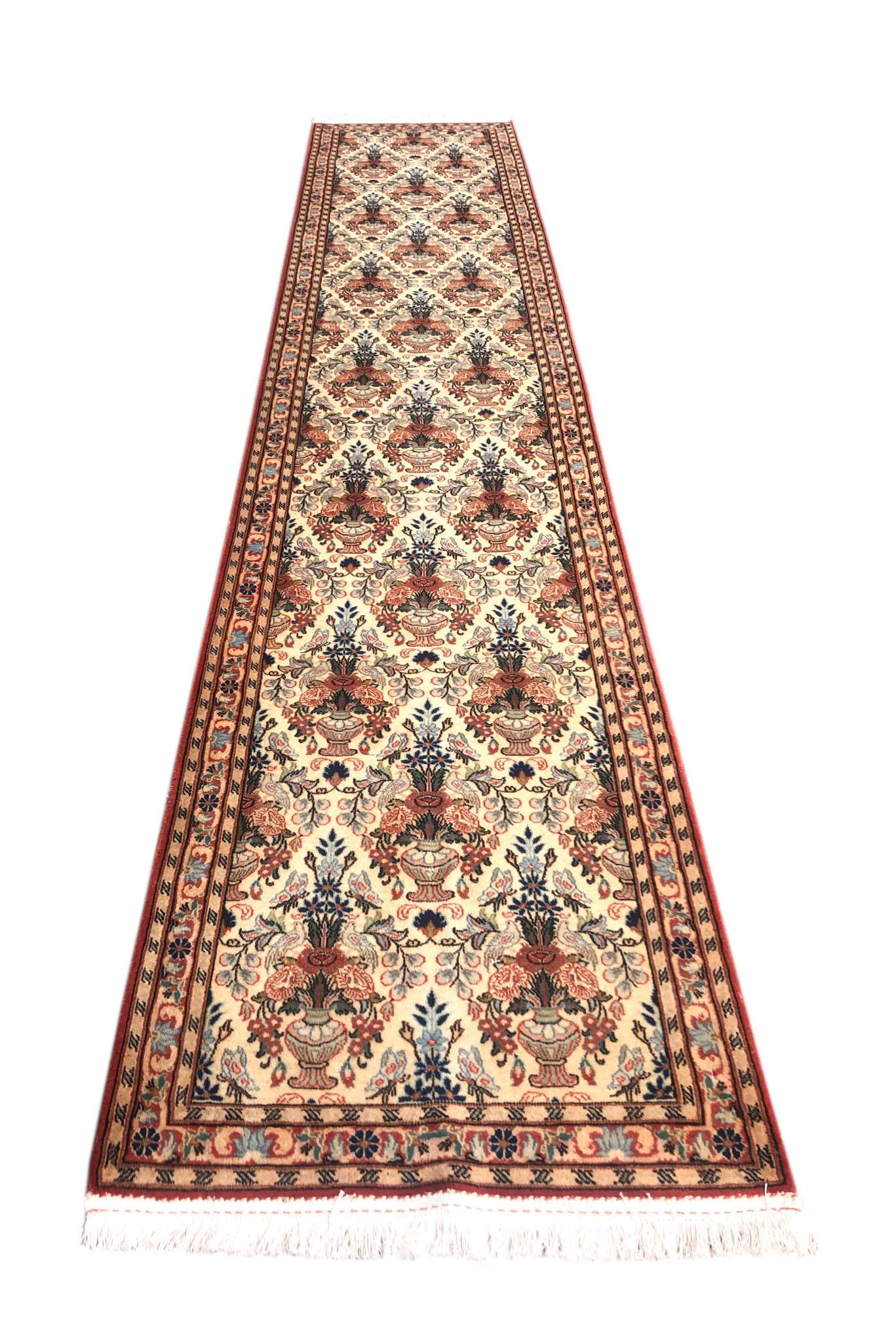 This is beautiful authentic Persian Qum runner, has a dramatic all-over floral vase design woven onto a cream background with a cream border. This pile is wool & silk on a cotton foundation. Dimensions are approximately size 2 feet 6 inch wide by 12