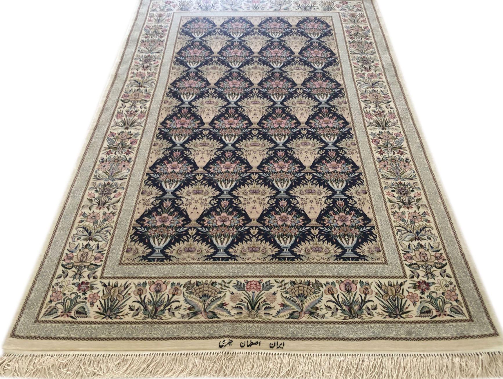 This authentic Persian Isfahan rug has wool and silk pile on silk foundation with an excellent condition. The color combination and design in this rug is absolutely outstanding. The base color is cream and the border is dark blue. This rug has