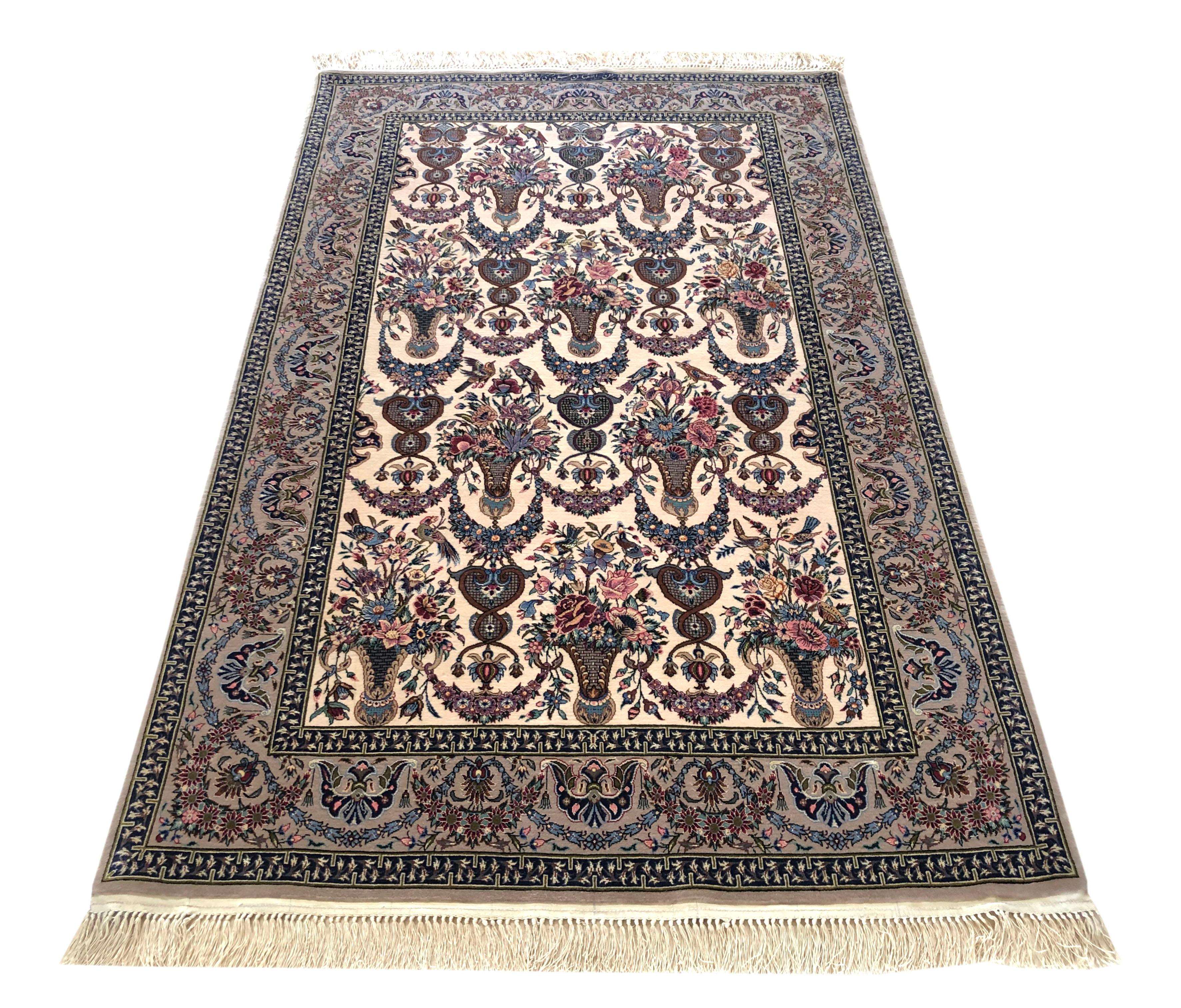 This authentic Persian Isfahan rug has wool and silk pile on silk foundation is a stunning example of a floral a-symmetrical vase design rug. This magnificent piece is most noticeable in its quality and color combination. This rug has signed by
